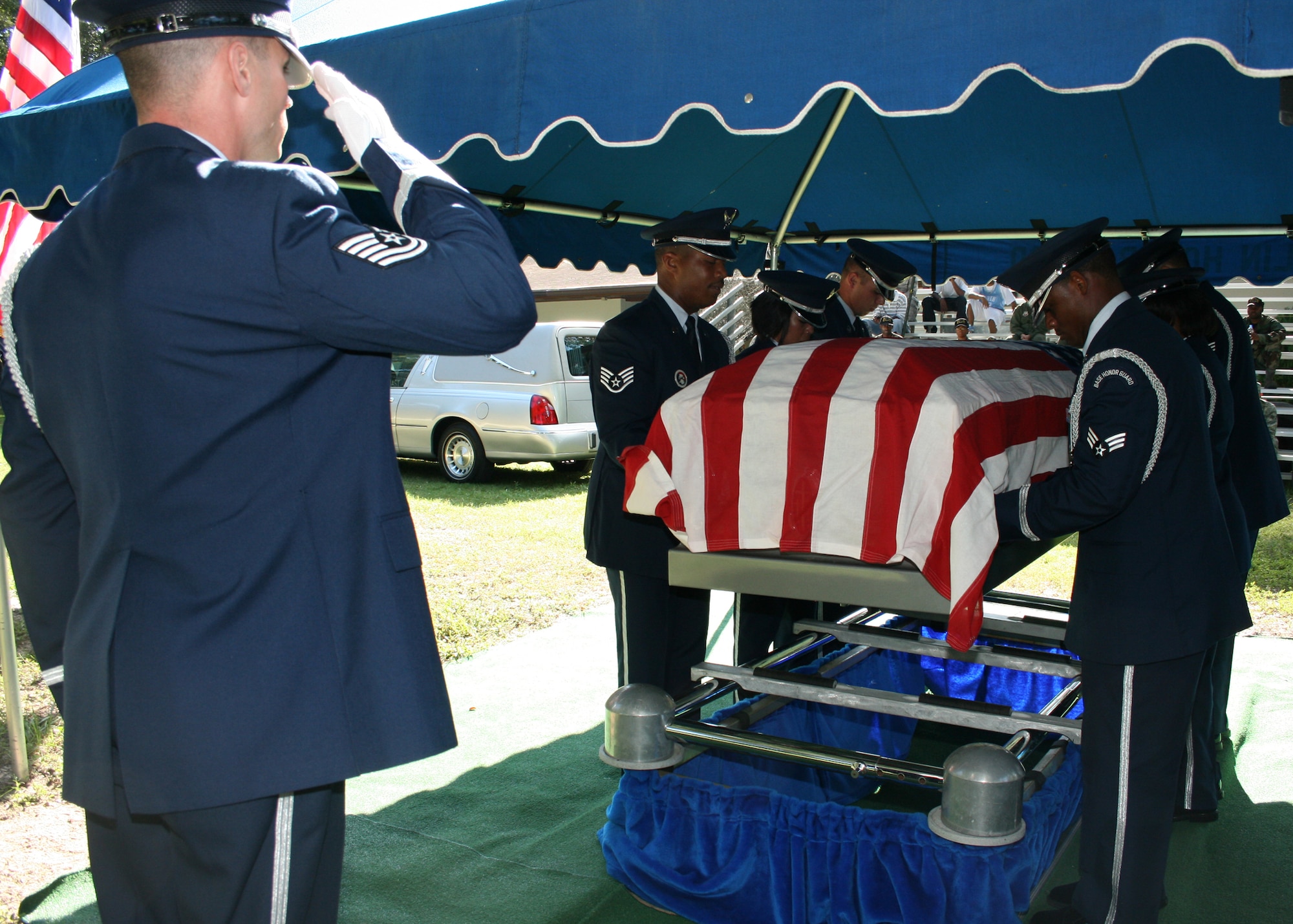 Tech. Sgt. Richard Hardin salutes the flag during a full military honors funeral demonstration Aug. 28 as part of the honor guard graduation. 15 Airmen graduated and will serve a six month tour as base honor guard before returning to their previous career field. Honor guard classes graduate every three months.  (U.S. Air Force photo/2nd. Lt. Andrew Caulk.)
