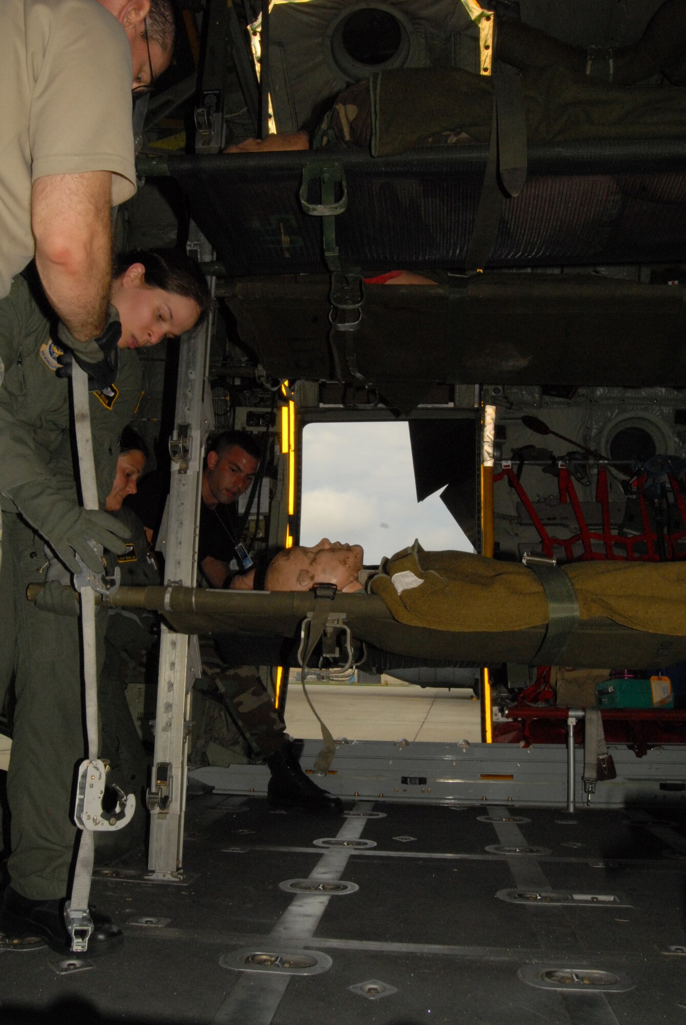 Members of the 43rd Aeromedical Evacuation Squadron configure  a C-130 for flight during a training mission Aug. 21. Members must know how to work together quickly to prepare the aircraft for flight. (U.S. Photo by Rhonda Griffin)