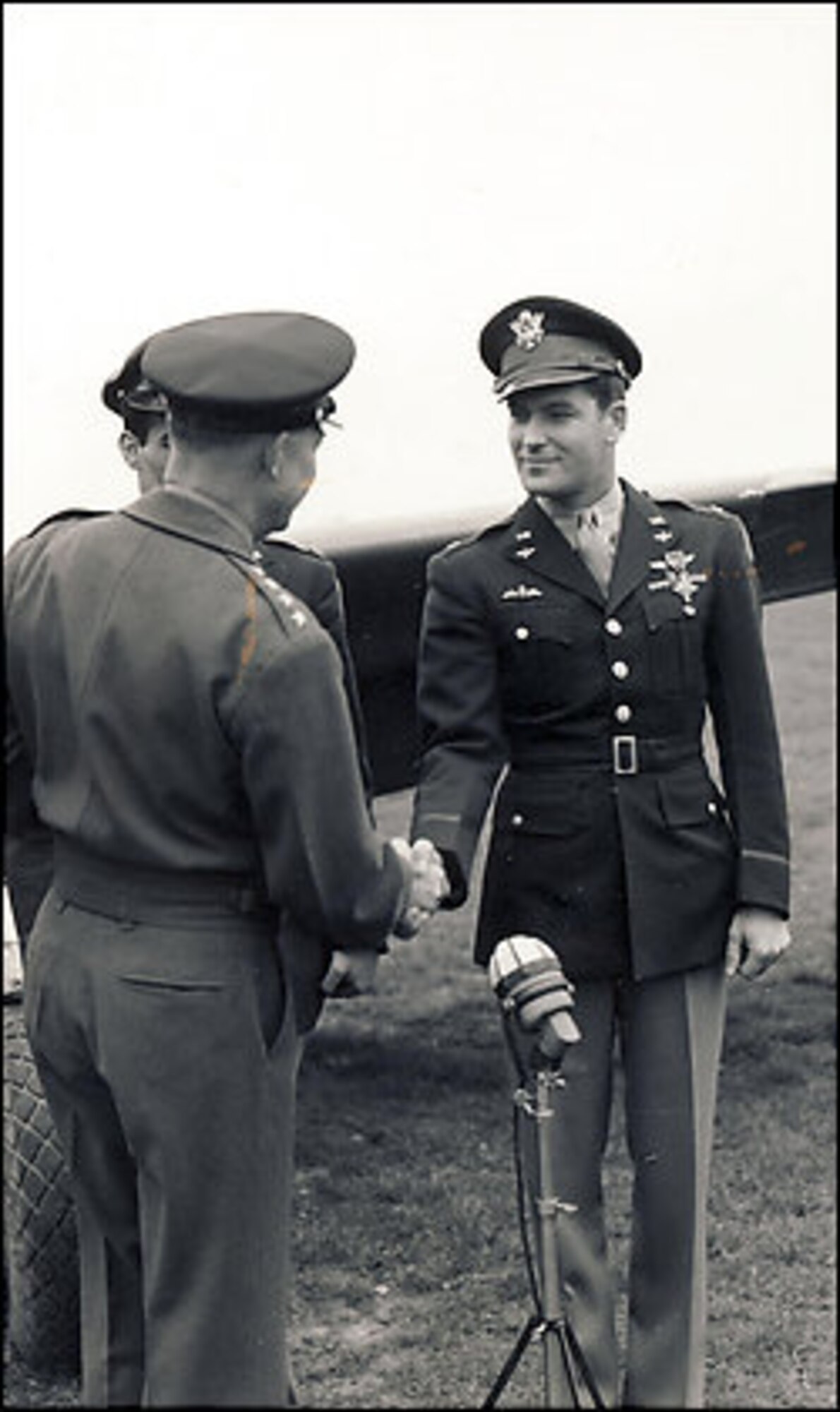 Col. Donald Blakeslee receives the Distinguished Service Cross from Gen. Dwight Eisenhower April 11, 1944. Colonel Blakeslee was commander of the first American fighter squadrons to reach Berlin during World War II. In the 4th Fighter Group Colonel Blakeslee was the first American P-47 Thunderbolt fighter pilot to shoot down a German aircraft. (Photo courtesy of the 8th Air Force Historical Society)