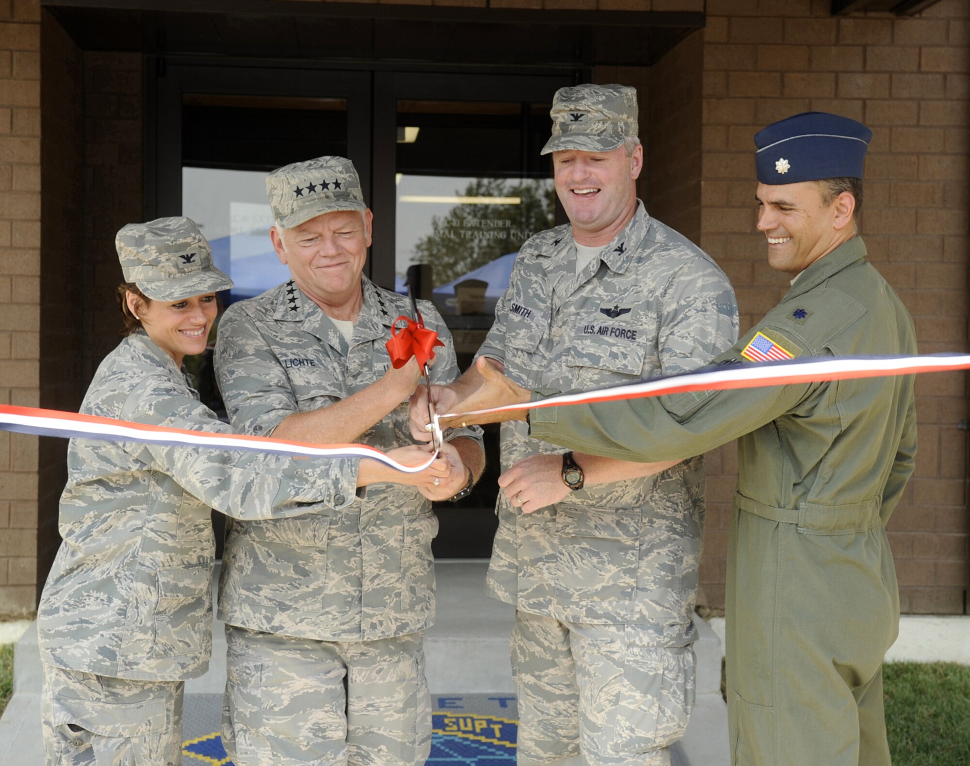 Left to right, Col. Gina Grosso, 87th Air Base Wing commander, Gen. Arthur Lichte, Air Mobility Command commander, Col. Scott Smith, 305th Air Mobility Wing commander, and Lt. Col. Michael Rickard, 305th Operations Support Squadron commander, participate in a ribbon-cutting ceremony for the new KC-10 Formal Training Unit building Aug. 26 here. During his time at McGuire, General Lichte visited several places around Joint Base McGuire-Dix-Lakehurst, including the U.S. Air Force Expeditionary Center. (U.S. Air Force photo/Carlos Cintron) 