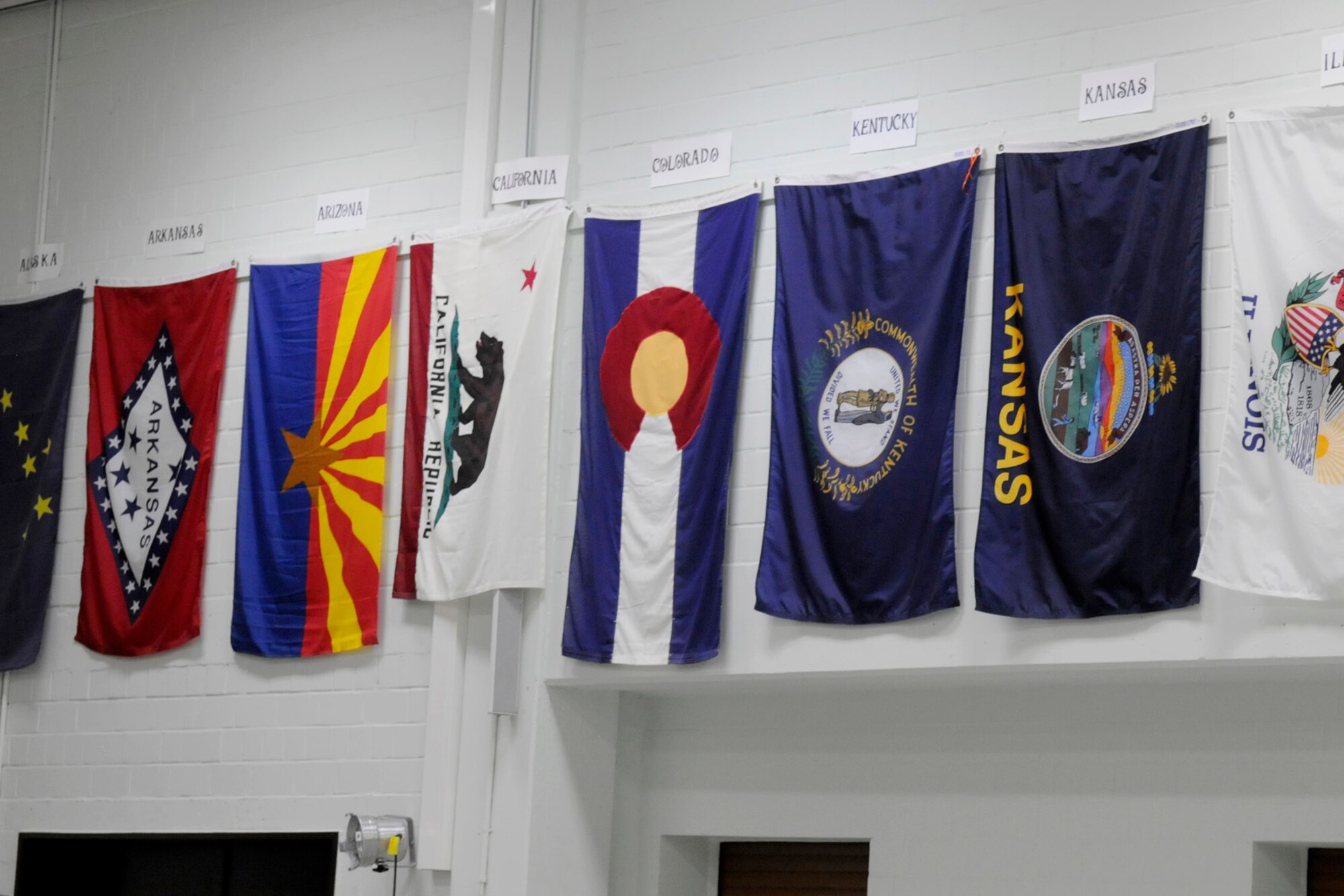 SPANGDAHLEM AIR BASE, Germany – Twenty-two members of the Air Force Sergeants’ Association Chapter 1681 hung and labeled all state and territory flags in the Spangdahlem Elementary School gym and presented a scrap book to the school as part of the AFSA Spangdahlem Elementary School state flag project Aug 28.  (U.S. Air Force photo/Airman 1st Class Staci Miller)