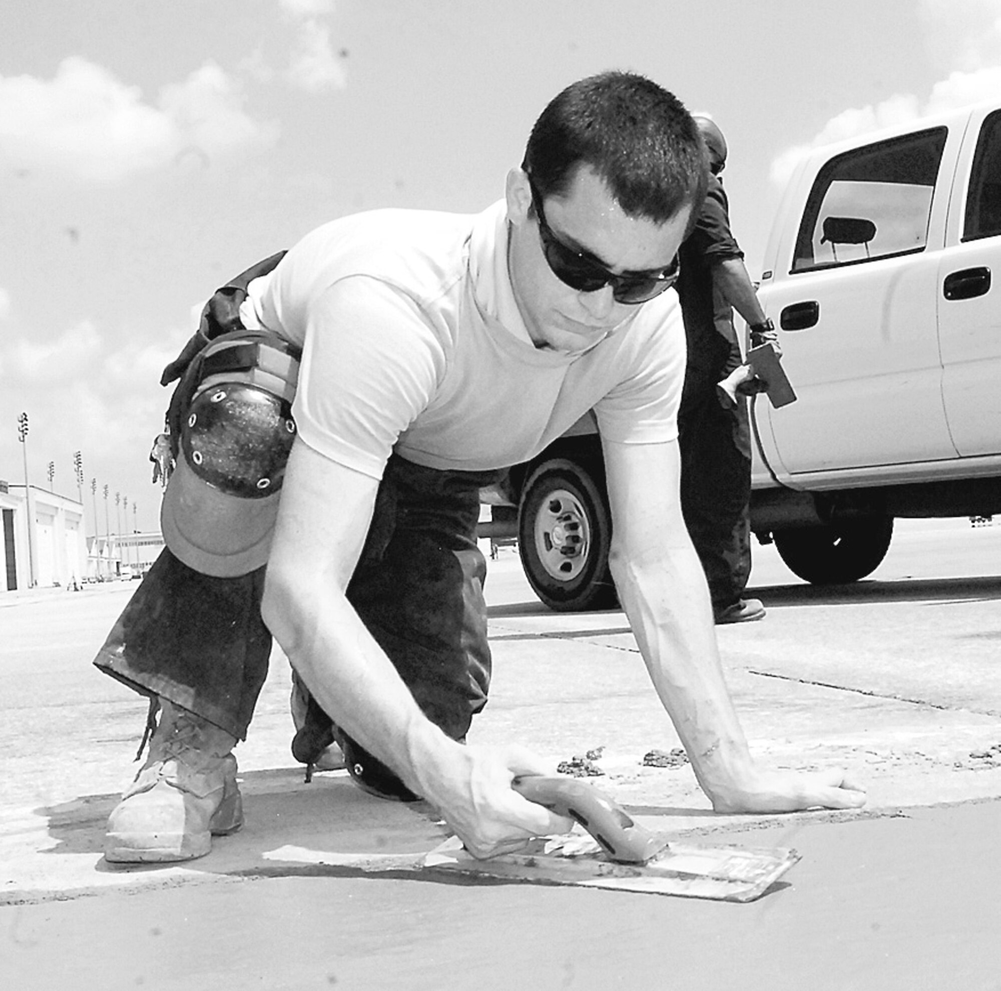 Senior Airman Christopher Gaudette, 43rd Civil Engineer Squadron, repairs defects in the concrete of the flightline Tuesday. Airman Gaudette helps to ensure all equipment is maintained and airfield pavements are sound for aircraft operations. (U.S. Photo by Senior Airman Mindy Bloem)