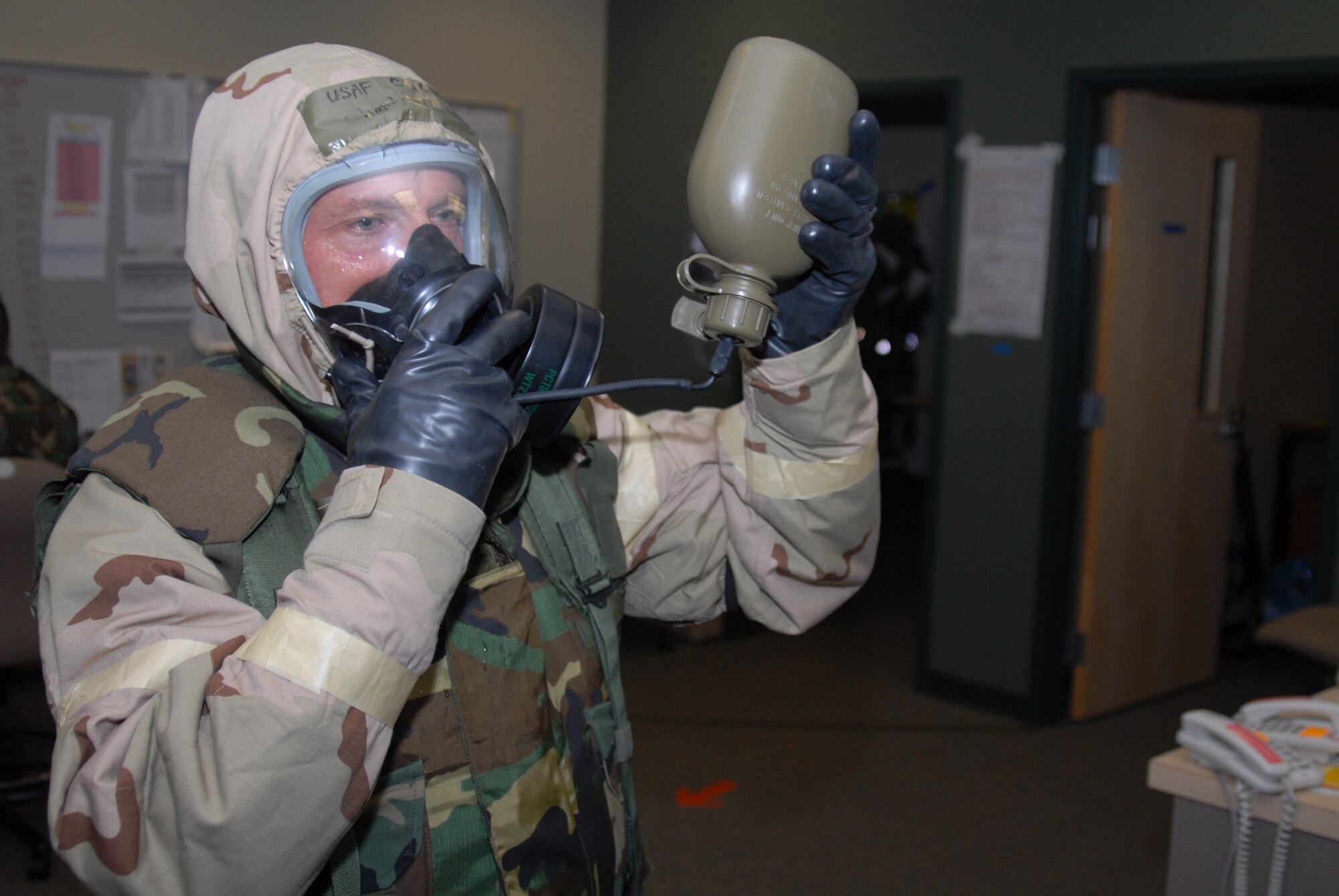 Col. Charles Dunn, 43rd Mission Support Group Commander, tests a canteen while at a Open Ranks Inspection Sept 4, 2008.