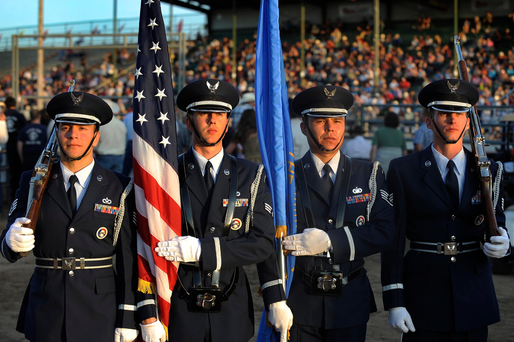 Members of the Ellsworth Honor Guard perform at the Central States Fair PRCA Range Day Rodeo in Rapid City, S.D., during military appreciation day August 27. The base honor guard emphasizes the importance of military customs and courtesies, dress and appearance, and drill and ceremonies. (U.S. Air Force photo by Airman 1st Class Corey Hook)