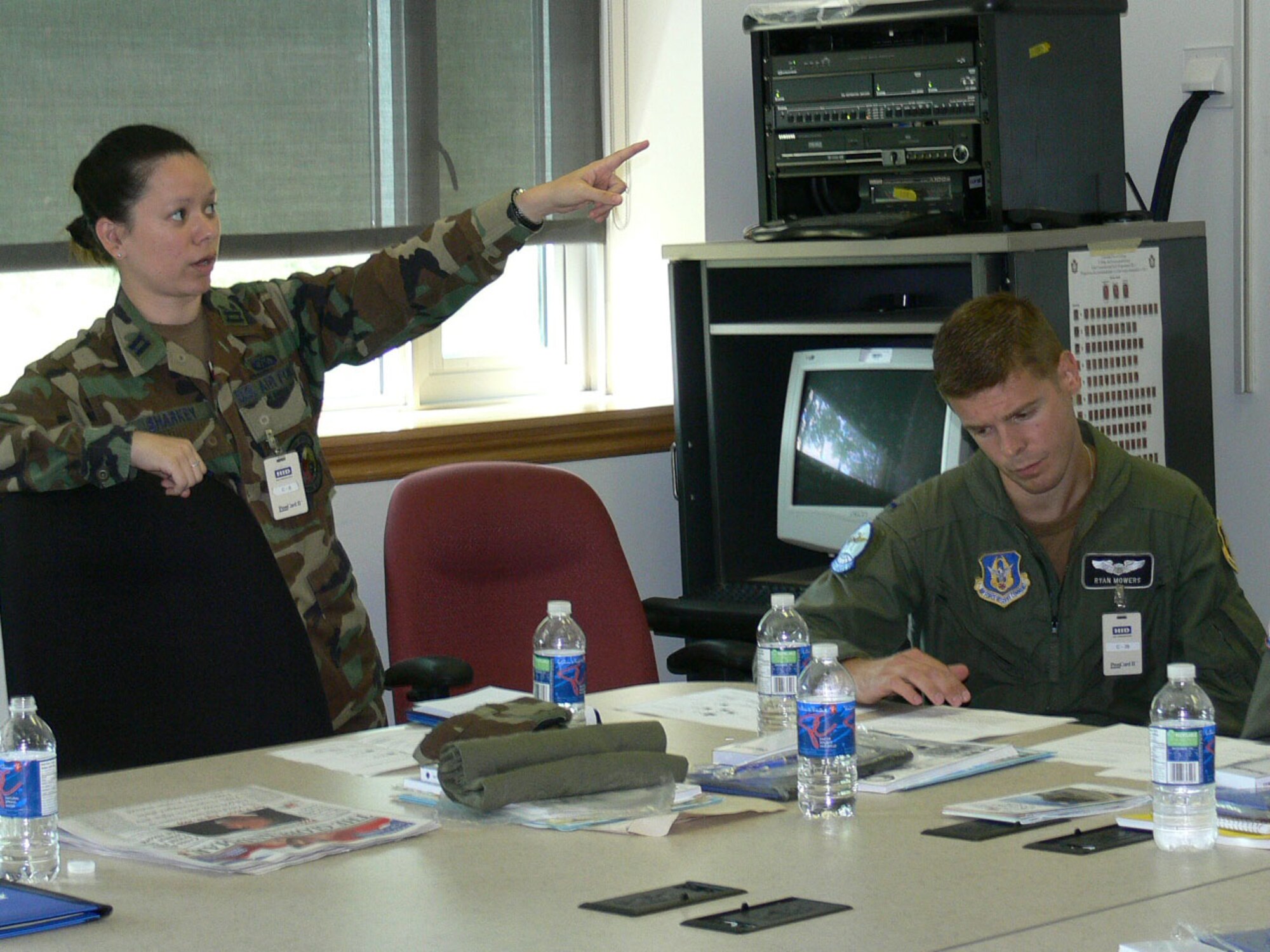 Captain Colleen Sharkey from the 701 COS, March ARB, Ca makes a suggestion while 1st Lt Ryan Mowers from the 328 AS, Niagara Falls IA-ARS, N.Y. reads the case study during a problem solving exercise. International Junior Officers participated in leadership and problem solving exercises during the 2009 IJOLDS at the Canadian Forces College in Toronto, Ontario, Aug 17-21. 