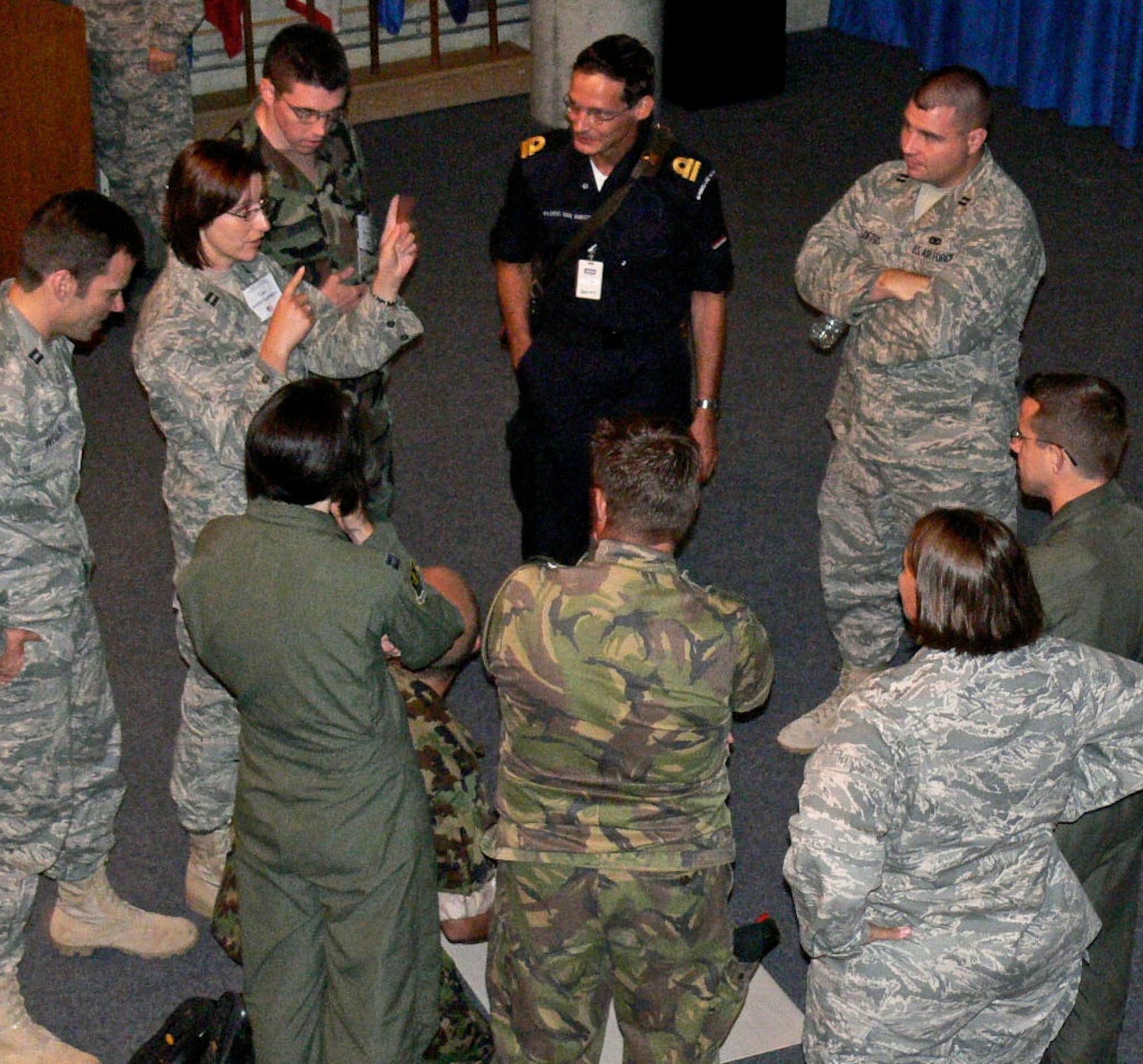 Junior officers discuss possible solutions during a critical thinking exercise during the 2009 IJOLDS. The International Junior Officer Development Seminar was held at Canadian Forces College in Toronto, Ontario from Aug 17-22.