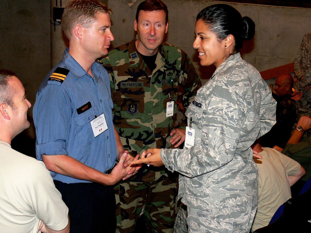 Capts Eugenia Ramirez of the 459 Air Refueling Wing, Andrews ABF, MD and Scott McPherson of the 482nd Civil Engineering Squadron, Homestead ARB, FL chats with classmates while on a break during the 2009 IJOLD Seminar held in Toronto Canada, Aug 17-21. (U.S. Air Force photo/2nd Lt Joe Simms)