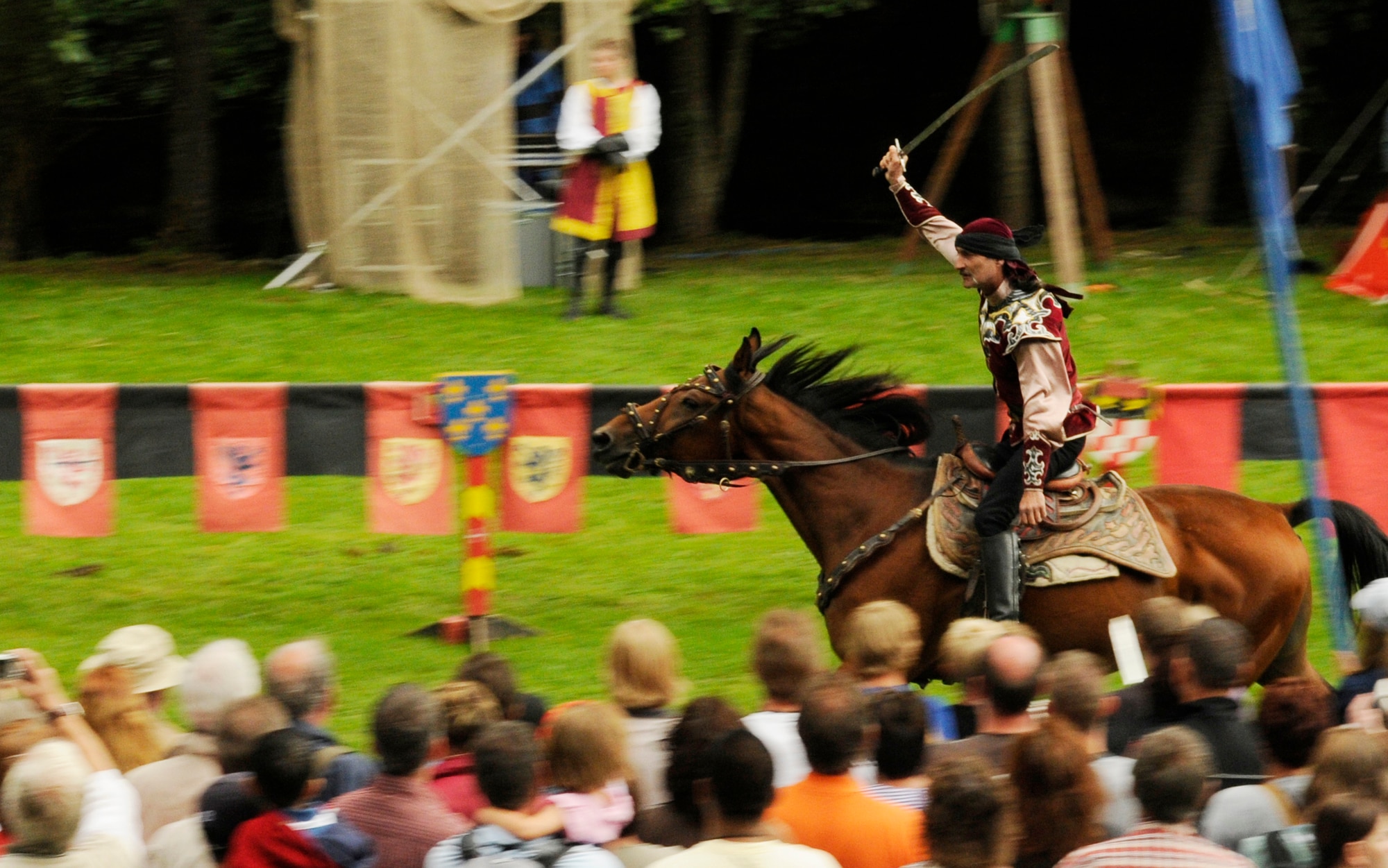 SPANGDAHLEM AIR BASE, Germany – An actor plays to the crowd after completing a challenge of swordplay during the first day of the Medieval Festival in Manderscheid, Germany, Aug. 29. The annual two-day festival included displays of traditional craftsman, sporting events, entertainment and food of the time. (U.S. Air Force photo/Senior Airman Benjamin Wilson)