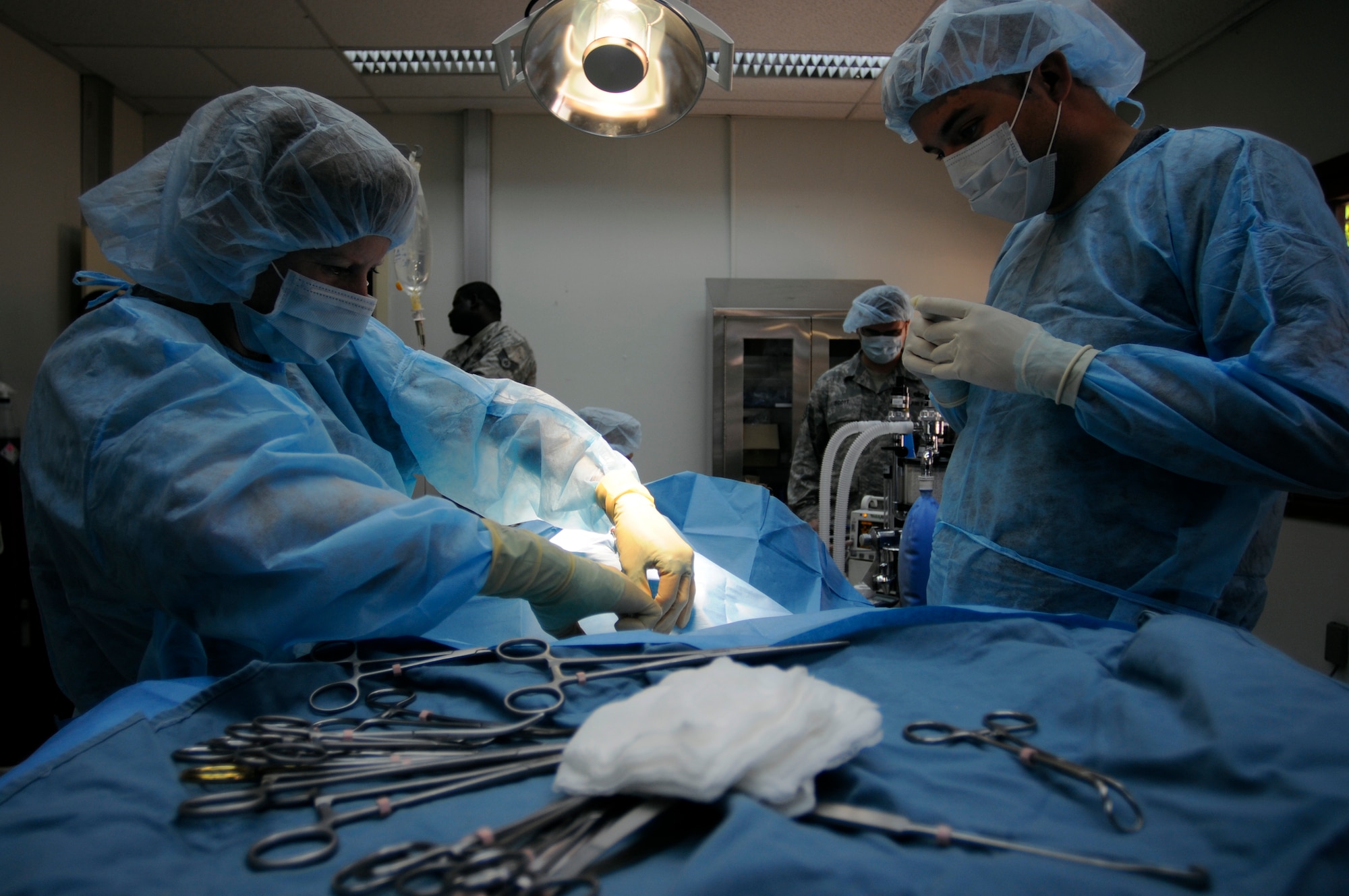 Army Maj. (Dr.) Katheryn Hanson, the Incirlik Veterinarian, and Staff Sgt. Eric Bonner, a 39th Security Forces Squadron military working dog handler, are ready to begin surgery on Suli, a 39th Security Forces Squadron military working dog, Thursday, Aug. 27, 2009 at the Veterinary Clinic, Incirlik Air Base, Turkey.  Suli received the prophylactic gastropexy, also referred to as stomach tacking, to prevent gastric torsion, or twisting of the stomach.  The surgery was completed after a recommendation by the Army, the service in charge of medical care for the military working dog program, for all dogs in the program to receive the surgery.  Stomach twisting is caused by gastric dilatation and volvulus, commonly known as bloat, the second leading killer of dogs after cancer.  (U.S. Air Force photo/Staff Sgt. Raymond Hoy)