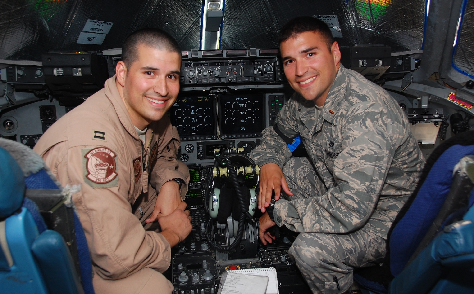 Capt. Bryan Lucero, a 817th Expeditionary Airlift Squadron C-17 Globemaster III pilot,(left) and his younger brother 2nd Lt. Nathan Lucero, 5th Expeditionary Aircraft Maintenance Squadron office in charge, are deployed together at an undisclosed location in Southwest Asia. As an aircraft maintenance officer, it is Lieutenant Lucero's job to ensure his brother's aircaft are fit to fly. Lieutenant Lucero is deployed from McChord Air Force Base, Wash., and Captain Lucero is deployed from Dover AFB, Del. The brothers hail from Albuquerque, N.M. (U.S. Air Force photo/Staff Sgt. Shaun Emery)
