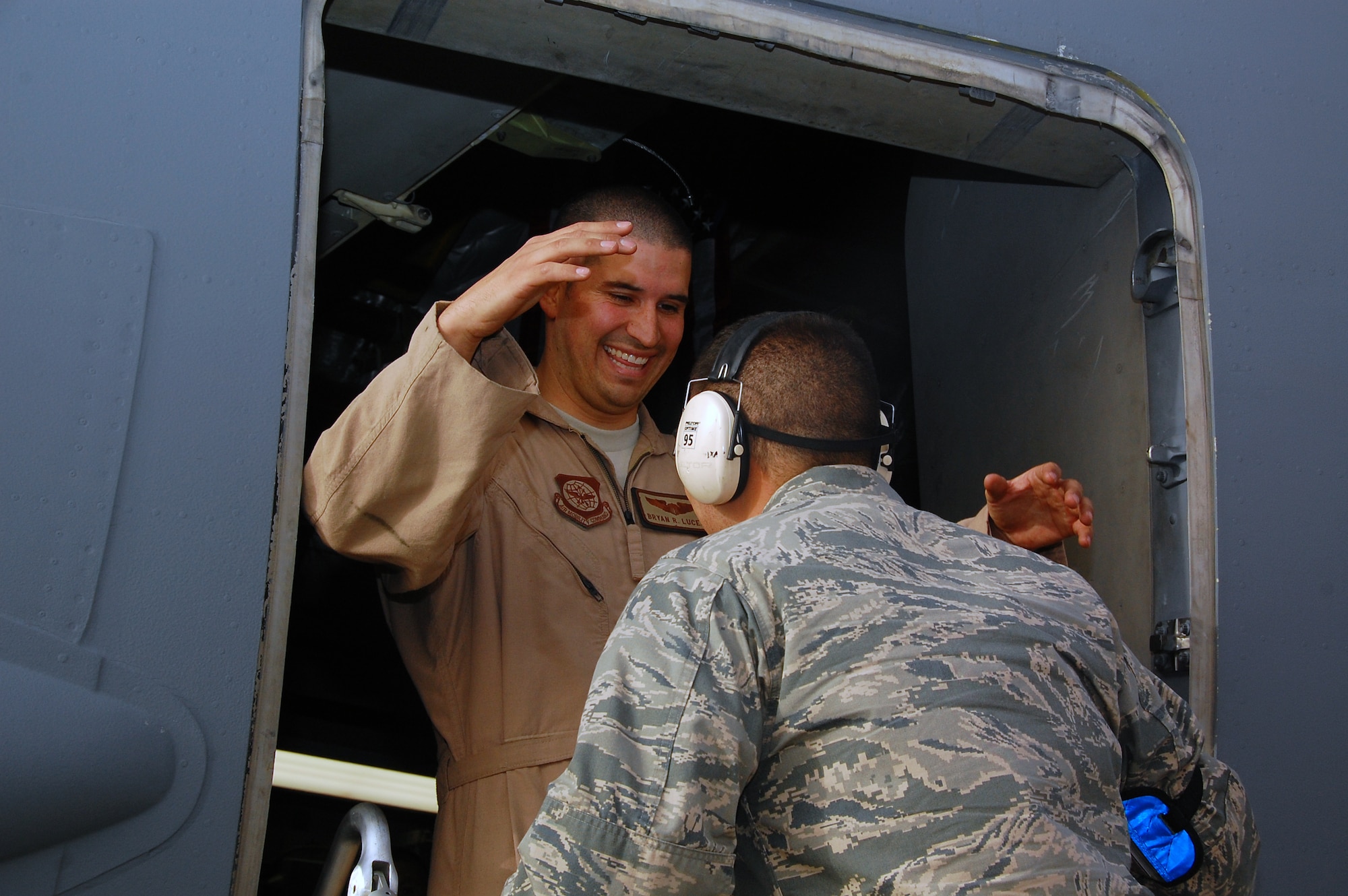 Capt. Bryan Lucero, a 817th Expeditionary Airlift Squadron C-17 Globemaster III pilot, is greeted by his younger brother 2nd Lt. Nathan Lucero, 5th Expeditionary Aircraft Maintenance Squadron office in charge, following the final flight of his four-month deployment to Southwest Asia. Captain Lucero is deployed from Dover  Air Force Base, Del., and Lieutenant Luceno is deployed from McChord AFB, Wash. (U.S. Air Force photo/Staff Sgt. Shaun Emery)