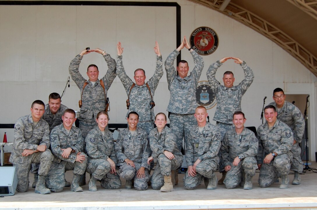 SOUTHWEST ASIA - The AFCENT Band MOJAVE, consisting of members from the Air National Guard Band of the Great Lakes, Swanton, OH, gave a command performance for dignitaries from the Midwestern United States.  (left to right) Maj. Gen. Gregory L. Wayt, Adjutant General for Ohio, and Maj. Gen. Edward W. Tonini, Adjutant General for Kentucky, and members of their staff formed the letters O-H-I-O to show their support of the band's home state after a performance of the Official Ohio State Rock Song, "Hang on Sloopy."  (U.S. Air Force courtesy photo)