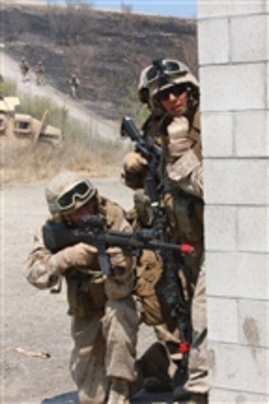 U.S. Marines with Military Police Company, Headquarters Battalion, 1st Marine Division ambush a simulated village during a training exercise at San Mateo on Camp Pendleton, Calif., on Aug. 13, 2009.  The Marines train for different scenarios in order to be combat-ready at all times.  