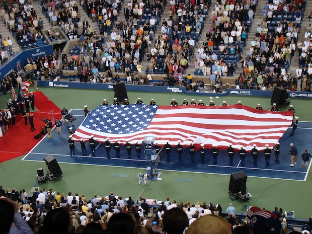 Marines from 6th Communications Battalion, 4th Marine Logistics Group, unfurl an American Flag across the tennis court during the opening ceremony for the U.S. Open at USTA Billie Jean King National Tennis Center, New York City. This is the 127th year of the annual tennis tournament. (Official Marine Corps photo by New York City Public Affairs Office)