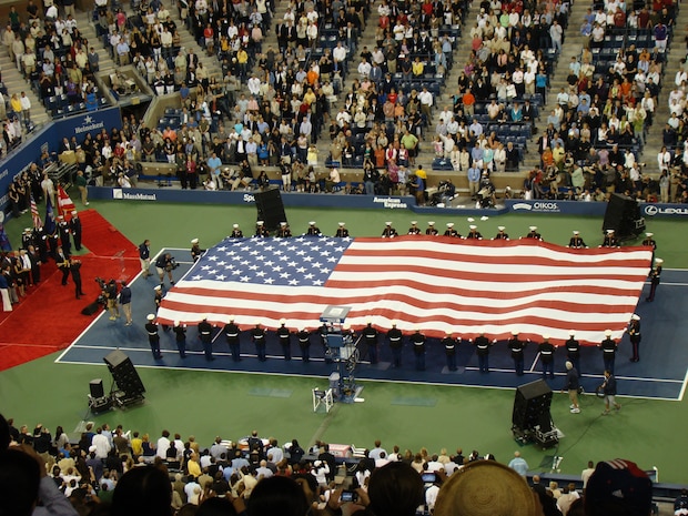 Marines from 6th Communications Battalion, 4th Marine Logistics Group, unfurl an American Flag across the tennis court during the opening ceremony for the U.S. Open at USTA Billie Jean King National Tennis Center, New York City. This is the 127th year of the annual tennis tournament. (Official Marine Corps photo by New York City Public Affairs Office)