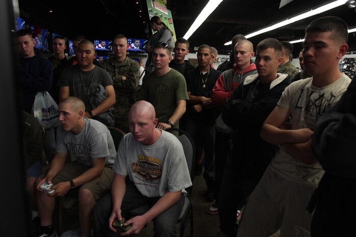 Marines watch the unfolding battle of "Call of Duty: Modern Warfare 2" during the Call of Duty Modern Warfare 2 Tournament 2 held at the Single Marine Program Shopping Night Dec. 1.