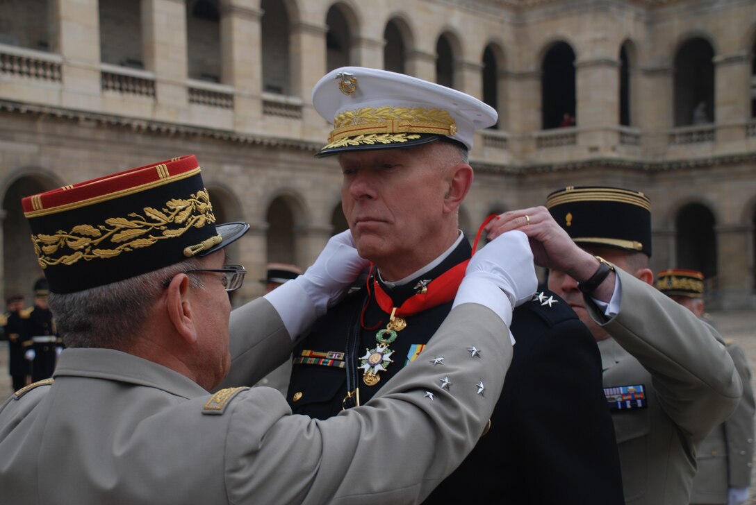 Gen. James T. Conway, the 34th Commandant of the United States Marine Corps, is presented with France's National Order of the Legion of Honour during a military awards ceremony at the historic Les Invalides here Dec. 1. The Chief of Staff of the French Army Gen. Elrick Irastorza presented the award, which included a full military pageant, featuring platoons of French honor guardsman, a ceremonial band, and French and American military representatives.