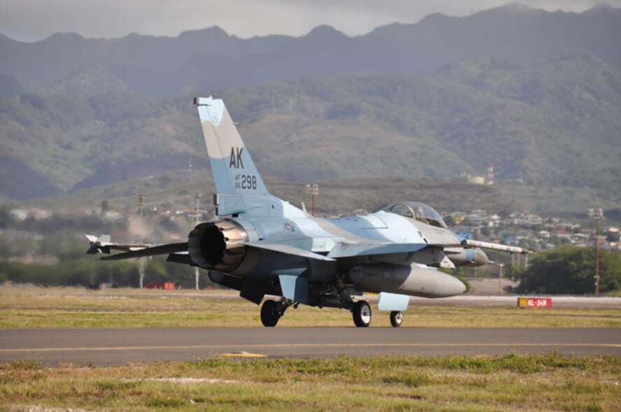 A pilot from the 18th Aggressor Squadron taxis an F-16 Fighting Falcon Agressor aircraft onto the runway at Hickam Air Force Base, Hawaii. The squadron, from Eielson Air Force Base, Alaska, functions to train aircrews through realistic threat replication in a simulated combat environment. It deploys mobile training teams throughout PACAF from April through October each year to conduct unit-level training. (Department of Defense photo/Cohen A. Young)