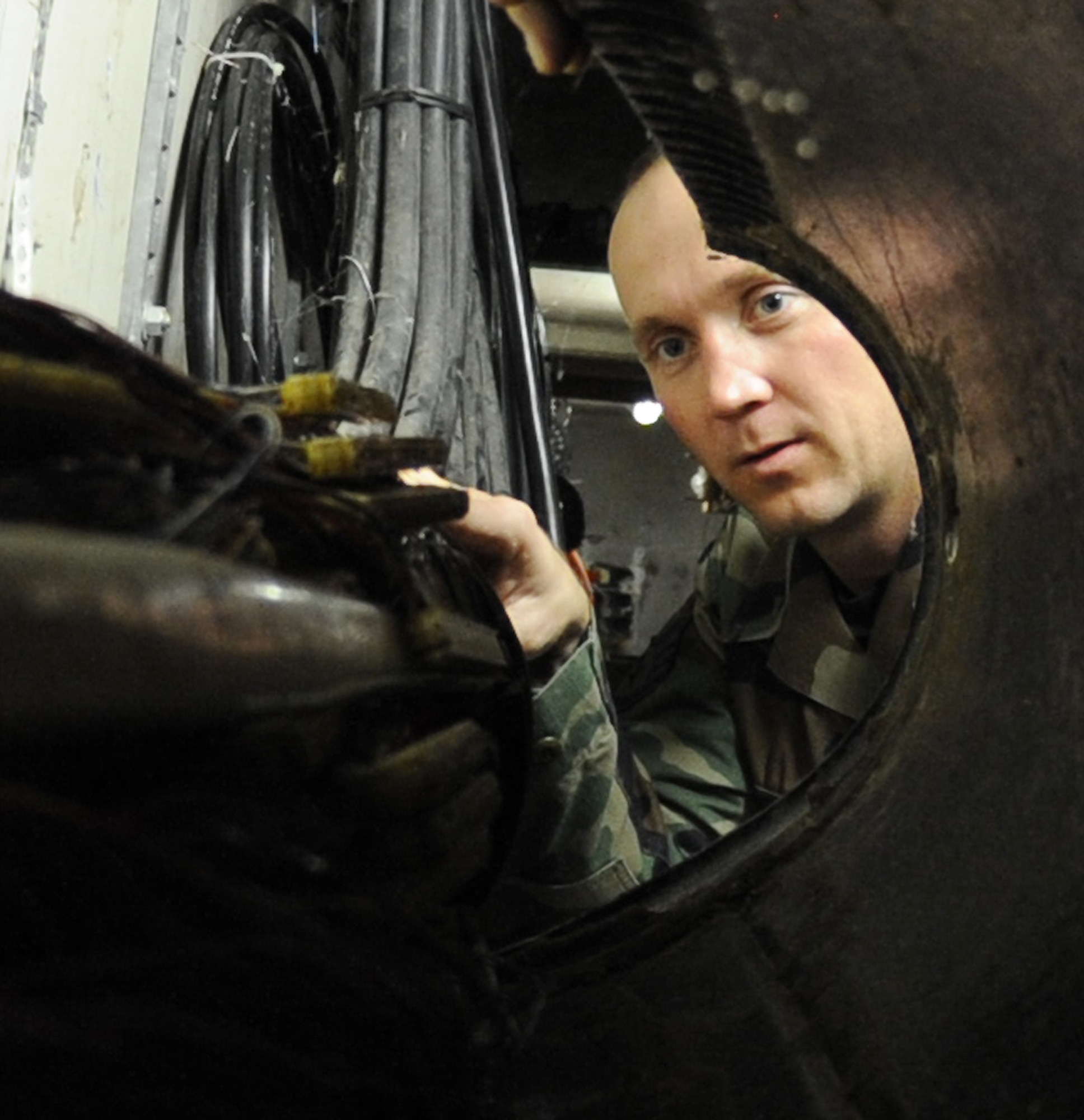 WHITEMAN AIR FORCE BASE, Mo., - Staff Sgt. Carl Smith, 509th Communications Squadron, inspects the main network lines exiting the communication focal point, for wear and tear, Dec. 1. The communication focal point provides customers on base a one-stop shop, servicing phone and network servers, base-wide.  (U.S. Air Force Photo/Airman 1st Class Carlin Leslie)(released)