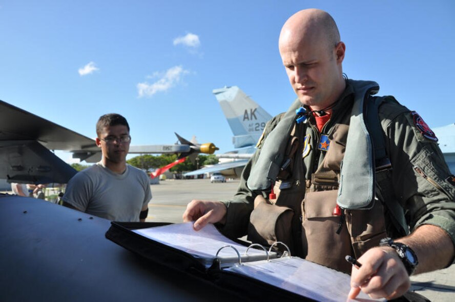 Capt. Dave Andersen, 18th Aggressor Squadron pilot, prepares for a large force employment exercise at Hickam Air Force Base, Hawaii. The squadron, from Eielson Air Force Base, Alaska, functions to train aircrews through realistic threat replication in a simulated combat environment. It.deploys mobile training teams throughout PACAF from April through October each year to conduct unit-level training. (Department of Defense photo/Cohen A. Young)