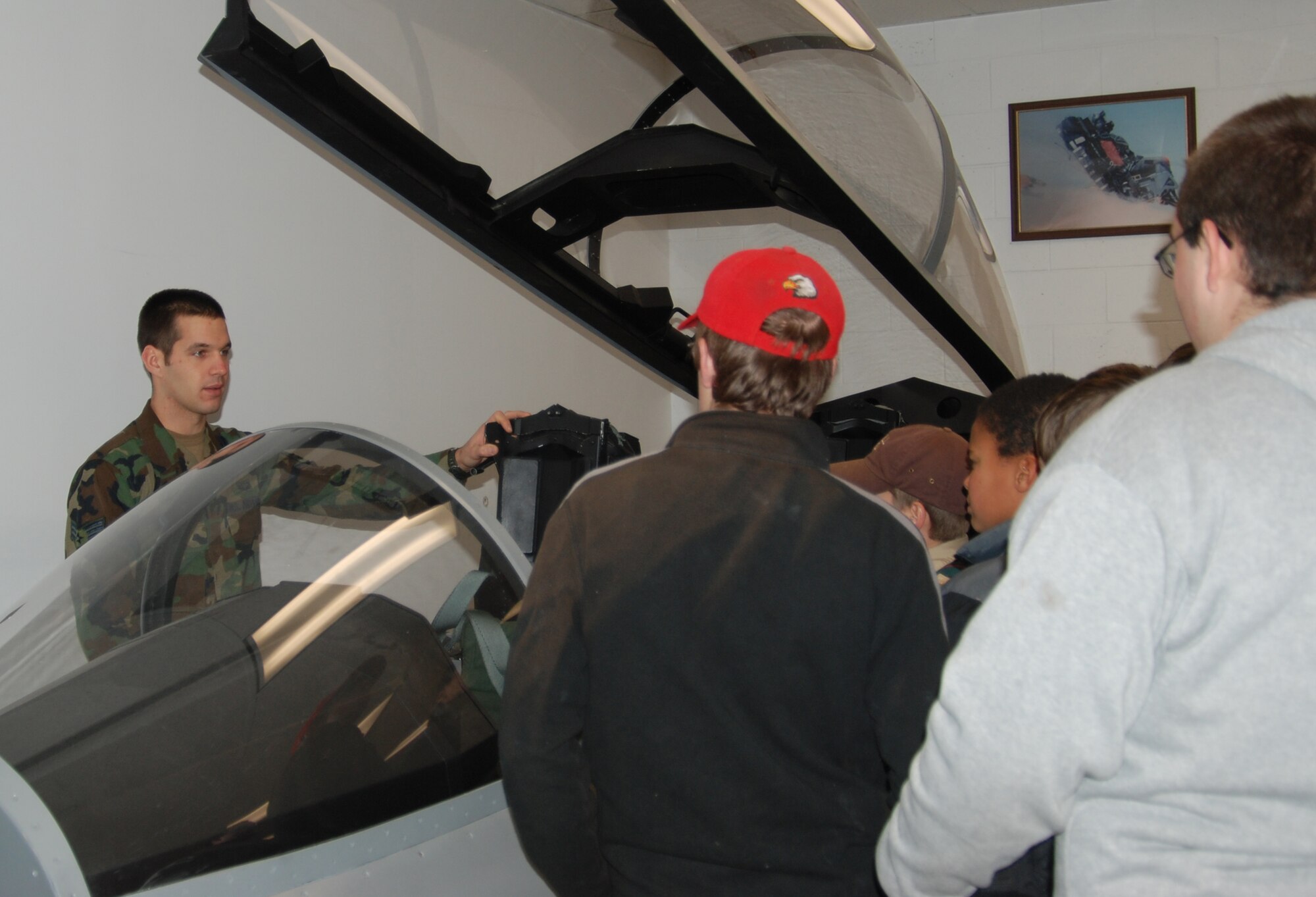 MOUNTAIN HOME AIR FORCE BASE, Idaho -- Senior Airman Paul Daggett, 366th Operations Support Squadron Survival, Evasion, Resistance and Escape specialist, shows the F-15E egress trainer jet to Boy Scouts from Boise troop 33 during a base tour Nov. 21. (U.S. Air Force photo by Capt. Jim Harris)
