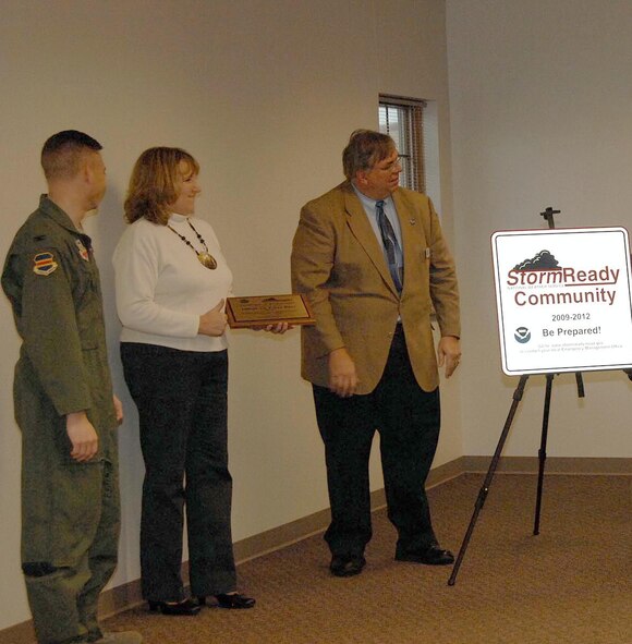 OFFUTT AIR FORCE BASE, Neb. -- From left to right, Col. John T. Rauch, 55th Wing vice commander, Rhonda L. Woolridge, chief of emergency management for the 55th Civil Engineer Squadron and Brian E. Smith, a warning coordination meteorologist with the National Weather Service, share friendly conversation after Mr. Smith presented Col. Rauch and Ms. Woolridge with the Storm Ready certificate of achievement Nov. 24 at the Bellevue Public Schools Support Center in Bellevue, Neb. Mr. Smith presented the colonel and Ms. Woolridge with the honor after the Defense Support for Civlian Authorities Briefing, a presentation that explains how Department of Defense agencies can help civilian agencies respond to a natrual disaster or crisis situation. Offutt is one of three Air Force installations that has recieved the award since the program's inception. U.S. Air Force Photo by Kendra Williams