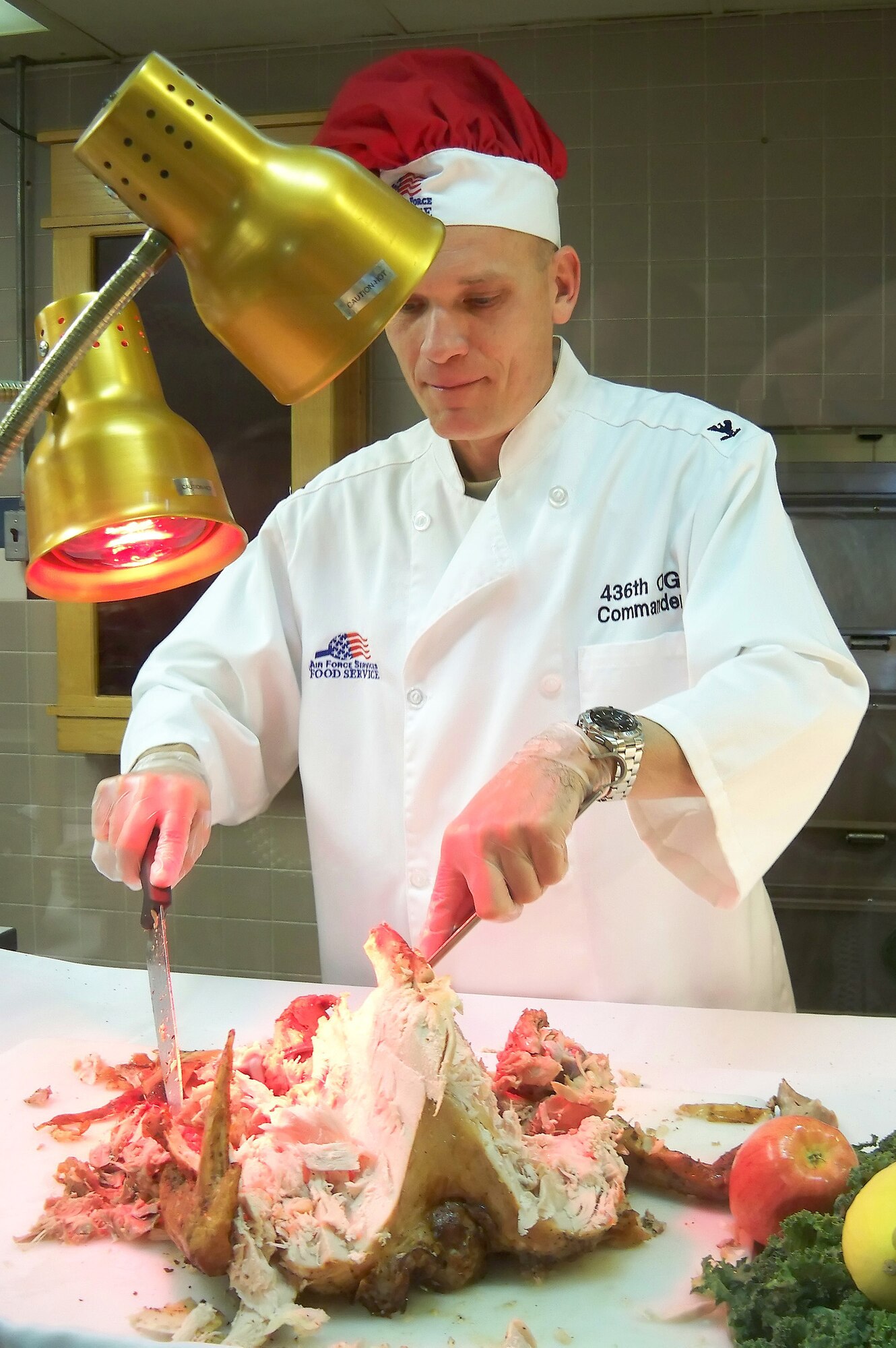 Col. David Horton, 436th Operations Group commander, carves a turkey at the Patterson Dining Facility Nov. 26. Wing leadership served Thanksgiving meals to Dover Airmen and retirees for the special occasion. (U.S. Air Force photo/ Airman 1st Class Shen-Chia Chu)