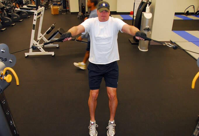 Tech. Sgt. Fred Furches performs a set of 10 cable rows during a strength training workout at the Fitness and Sports Center here Nov. 30. Sergeant Furches makes time for the gym six days-a-week and wasted no time in getting back in the gym after Thanksgiving to keep on top of his fitness during the holiday season. Sergeant Furches is a training instructor with the 373rd Training Squadron. (U.S. Air Force photo/Staff Sgt. Daniel Bowles)