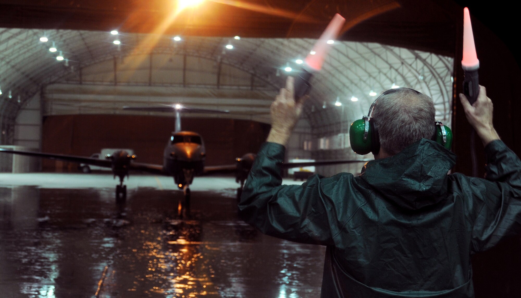 Gary Dunlap marshals out the 362nd Expeditionary Reconnaissance Squadron's 1,000th MC-12 Nov. 16, 2009, at Joint Base Balad, Iraq. Activated in June 2009, the 362nd reached 1,000 missions a few days past their five-month mark. Mr. Dunlap is a civilian contractor attached to the 362nd Expeditionary Reconnaissance Squadron. (U.S. Air Force photo/Senior Airman Christopher Hubenthal)