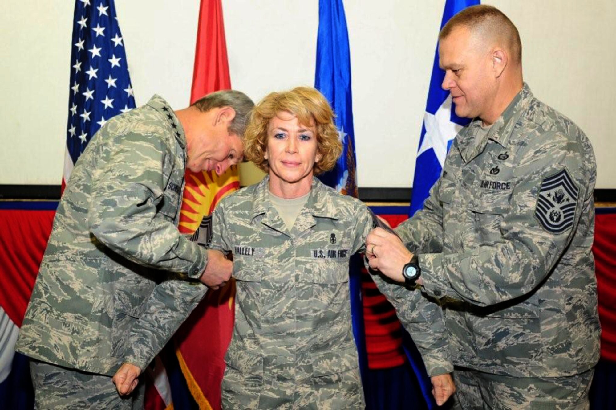TRANSIT CENTER AT MANAS, Kyrgyzstan -- Chief Master Sgt. Dianna Vallely stands while Air Force Chief of Staff Gen. Norton Schwartz and Chief Master Sergeant of the Air Force James Roy pin on her chevrons during a promotion ceremony Dec. 1 at the Transit Center in Manas, Kyrgyzstan. December 1, marks the 50th anniversary of the creation of the rank of chief master sergeant. Chief Vallely, now a member of the enlisted force's top one percent, is deployed from Moody Air Force Base, Ga. (U.S. Air Force photo by Senior Airman Steele Britton)

