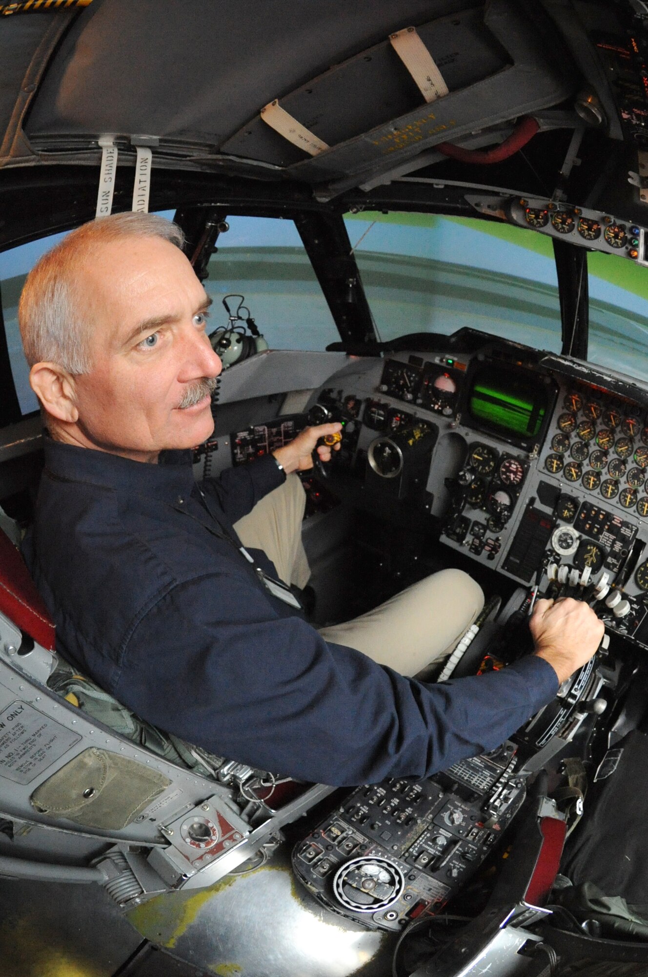 MINOT AIR FORCE BASE, N.D. -- Glynn Breuer, contract console operator for Rockwell Collins, demonstrates the Weapons Systems Trainer of a B-52H Stratofortress flight simulator here Nov. 30. The trainer allows for the most accurate flight simulation of the B-52, additionally to help provide comprehensive systems management and life-cycle support services for B-52 aircrew training. (U.S. Air Force photo by Airman 1st Class Jesse Lopez)