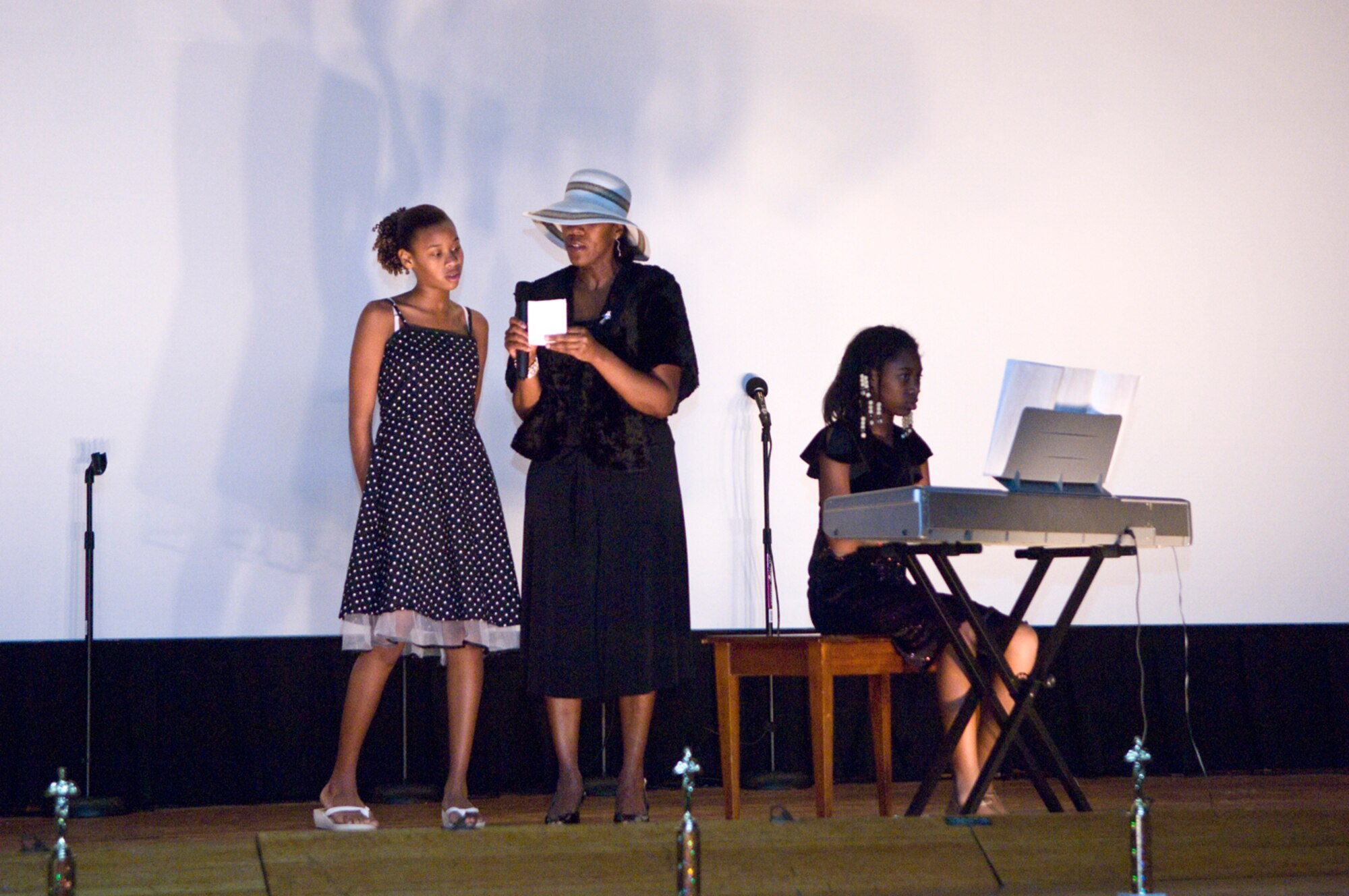 HANSCOM AIR FORCE BASE, Mass. – The 66th Force Support Squadron hosted its annual talent contest at the Base Theater on Nov. 19. Pictured here competing in the Parent and Youth category, The Gulley Family, from left, Ytrenda, Tamala, and Brenda Gulley perform their number for the audience. The Gulley family won first place in their category. Other first place winners included Autumn Pierce, children’s category; Colin Canavan, preteen category; Felicia Dozier, teen individual vocal category; Bailey Orr, teen individual instrument category; and Raven Shrader, teen individual performance specialty category. (U.S. Air Force photo by Mark Herlihy)