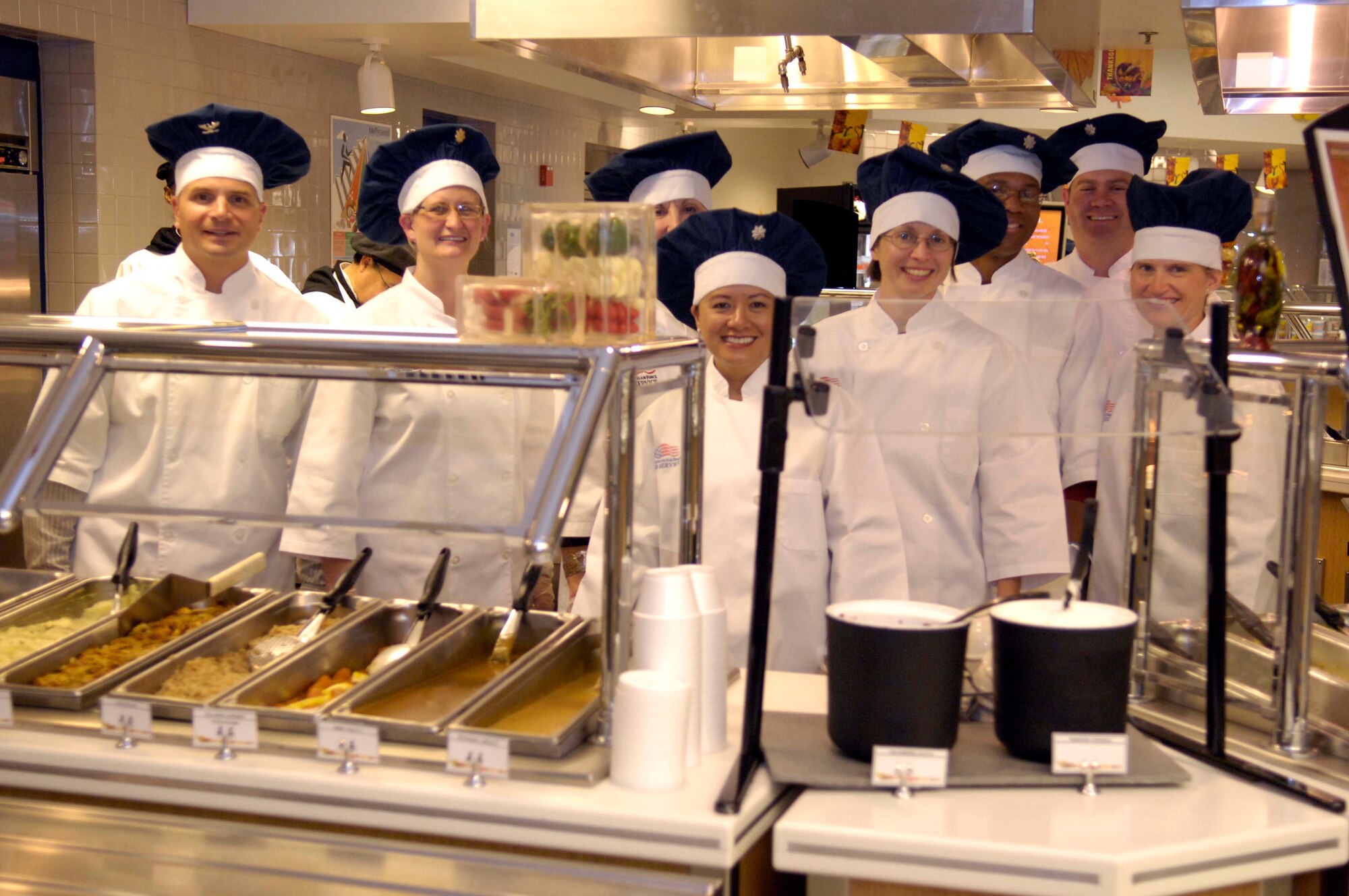 VANDENBERG AIR FORCE BASE, Calif. – Six commanders at Vandenberg Air Force Base pose for a photo at Breakers Dining Facility for Vandenberg’s Thanksgiving Luncheon, November 26, 2009. These 8 individuals completed the brunch shift after serving patrons their thanksgiving meal. (U.S. Air Force photo/ Airman 1st Class Lael Huss) 