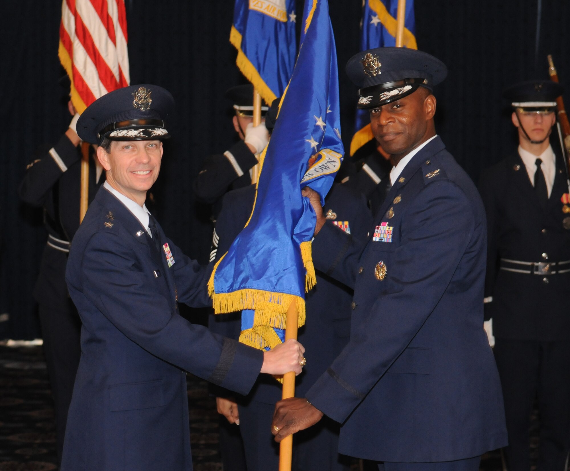 Col. Cedric D. Jones accepts the 11th Wing guidon from Maj. Gen. Darrell D. Jones, Air Force District of Washington Commander, in an assumption of command ceremony Dec. 1 on Bolling Air Force Base, D.C. (U.S. Air Force photo by Senior Airman Sean Adams)