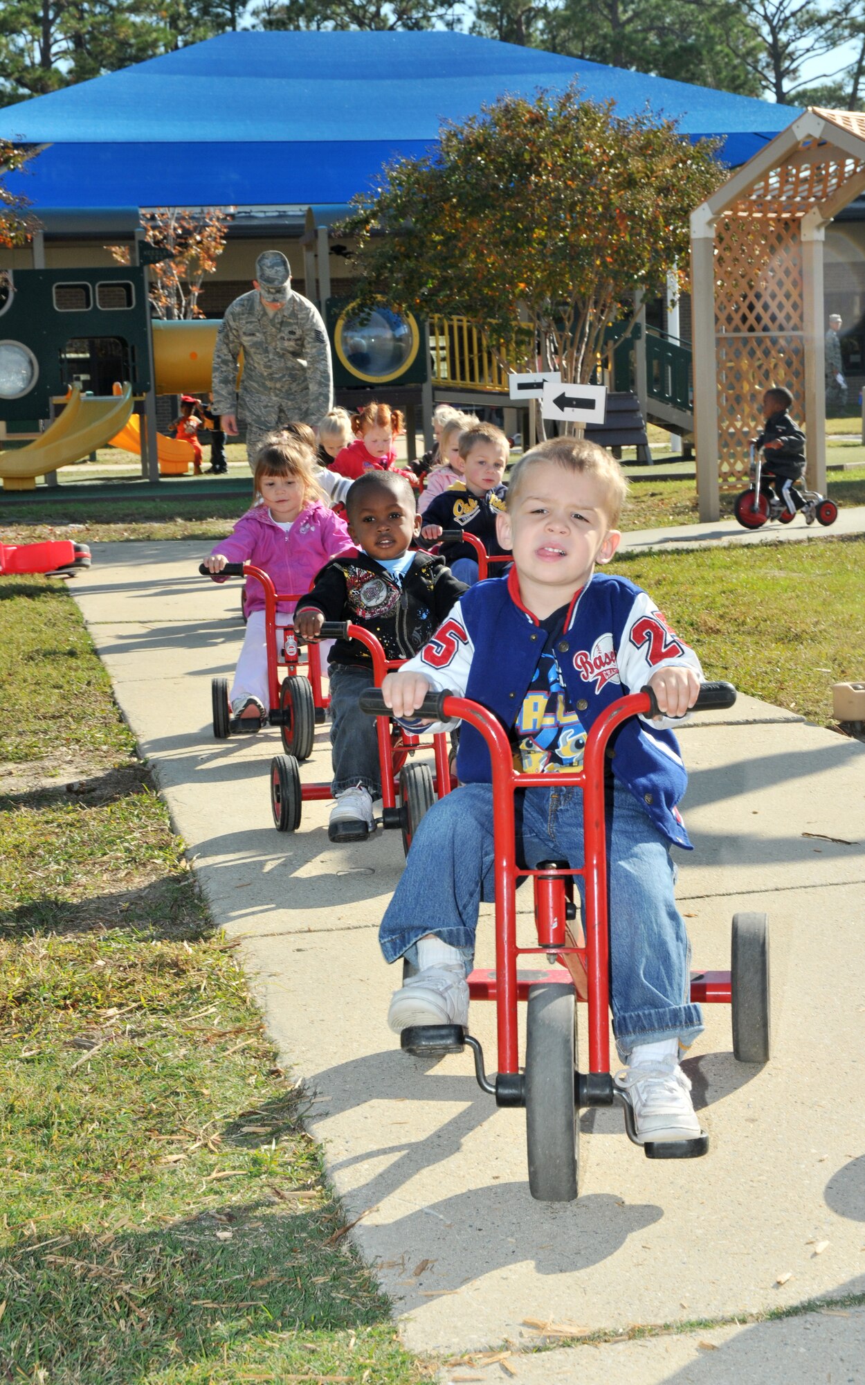 Preschoolers demonstrate their pedal power during the child development center’s annual trike-a-thon Friday.  (U.S. Air Force photo by Adam Bond)