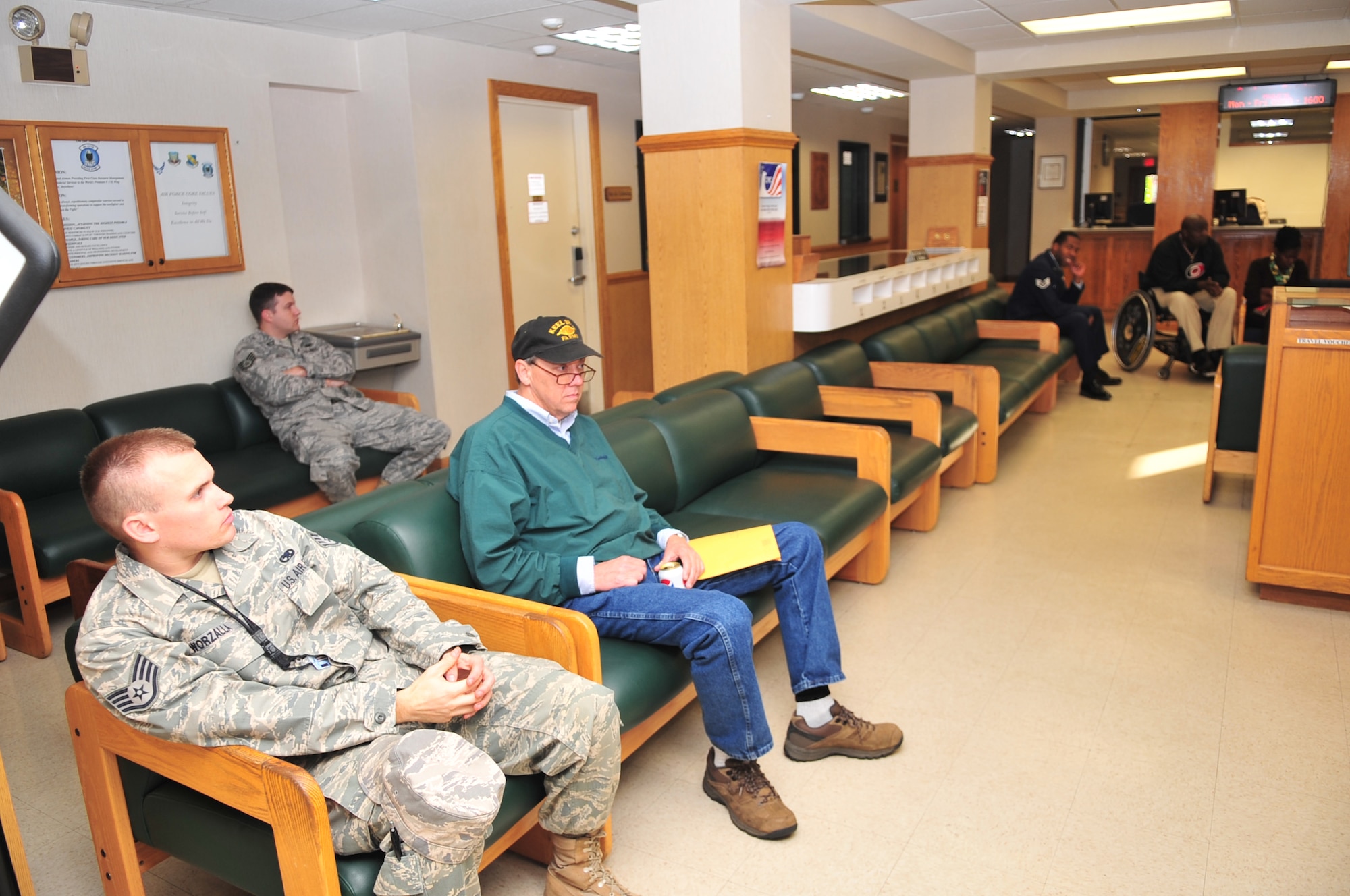 Airmen and retirees wait in the lobby of the military personnel section, now located in the finance building, for their turn to see a customer service representative on Seymour Johnson Air Force Base, N.C., Nov. 30, 2009. The MPS staff have the ability to fix and replace common access cards as well as fix discrepancies in awards, rank and leave. (U.S. Air Force photo/Airman 1st Class Rae Perry)