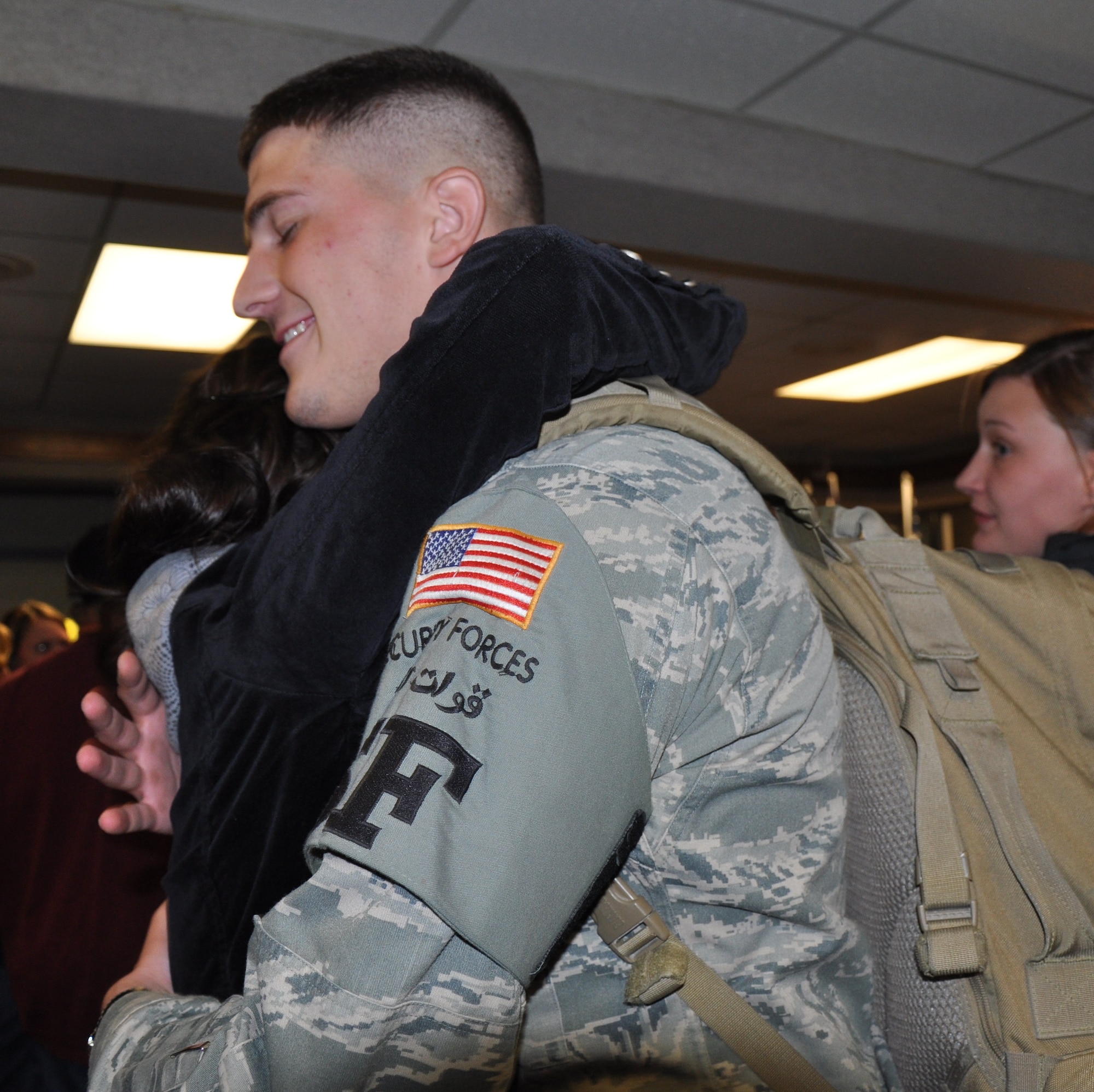 Airman 1st Class Danika Knudson, a friend of returning Airmen, welcomes back Airman 1st Class John Winter, 82nd Security Forces Squadron, from his deployment Nov. 25 at the Wichita Fall Municipal Airport. The Airmen were deployed for six months in Southwest Asia. (U.S. Air Force photo/Airman 1st Class Candy Miller)