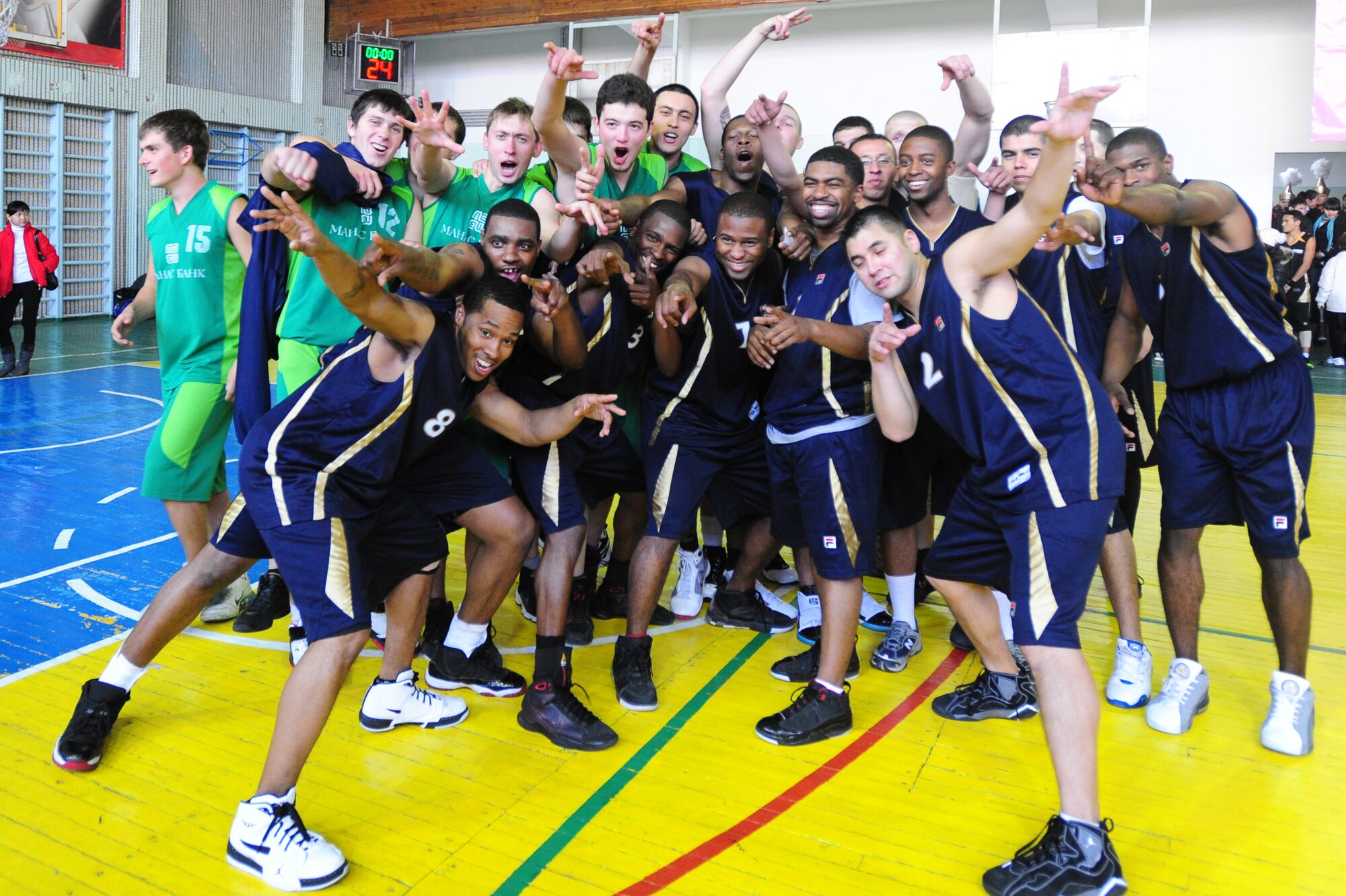 BISHKEK, Kyrgyzstan -- The Transit Center at Manas basketball team poses for a photo with the Kyrgyz basketball team following a friendly game in Bishkek, Nov. 20, 2009. The Transit Center Airmen pulled a victory after coming from behind with a final score of 93-86. (U.S. Air Force photo/Senior Airman Steele C. G. Britton)
