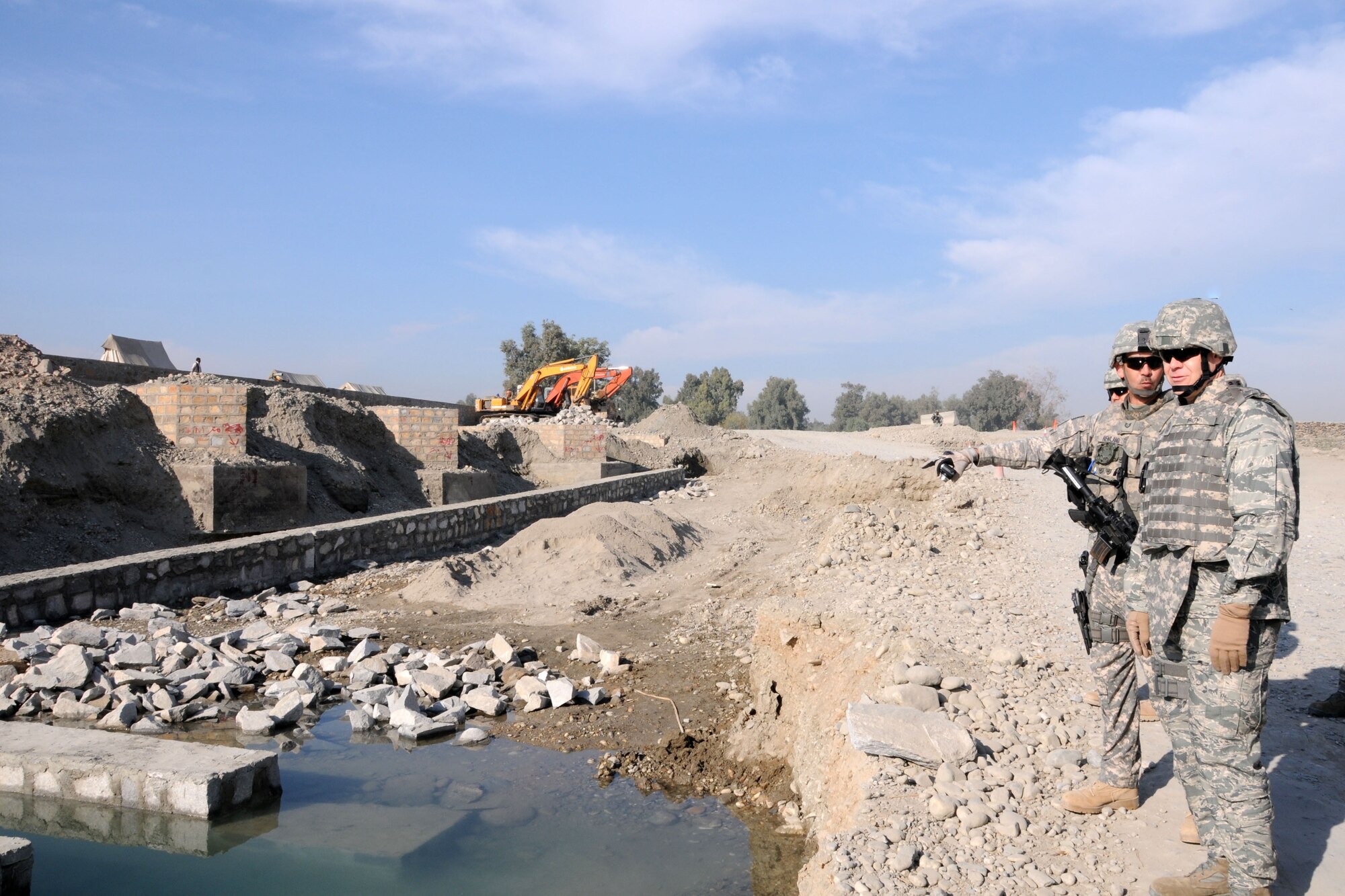 NANGARHAR PROVINCE, Afghanistan -- Chief Master Sgt. of the Air Force James Roy listens to U.S. Air Force Tech. Sgt. Shawn Newland, Nangarhar Provincial Reconstruction Team project manager deployed from the 99th Civil Engineer Squadron at Nellis Air Force Base, Nev., about ongoing construction of the Saracha Bridge in Jalalabad, Afghanistan, Nov. 28, 2009.  The CMSAF stopped to see Airmen accomplishing unique jobs associated with the PRT, and learn firsthand how Airmen view their deployment process and what improvements can be made for future Airmen.  (U.S. Air Force photo/Tech. Sgt. Brian Boisvert)