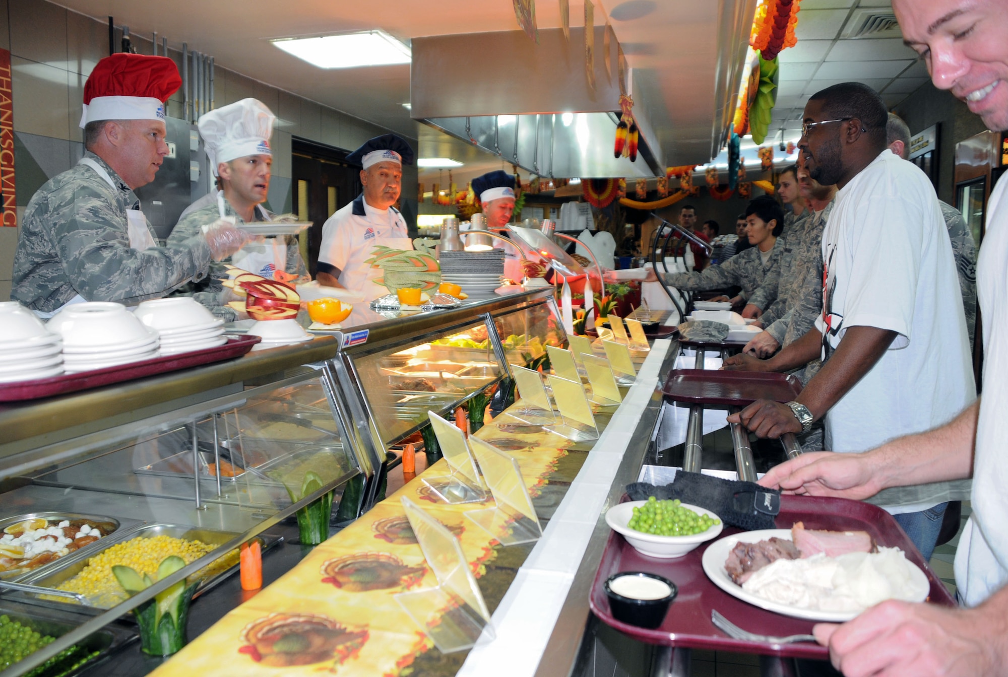 Col. Eric Beene, 39th Air Base Wing commander and Incirlik first sergeants serve Thanksgiving lunch to Airmen from all around base Thursday, Nov. 26, 2009, at the Sultan’s Inn Dining Facility. Members of the dining facility prepared turkey, roast beef, sweet potatoes and many more Thanksgiving treats for Airmen to eat and spend time together during the holiday. (U.S. Air Force photo/Senior Airman Sara Csurilla)