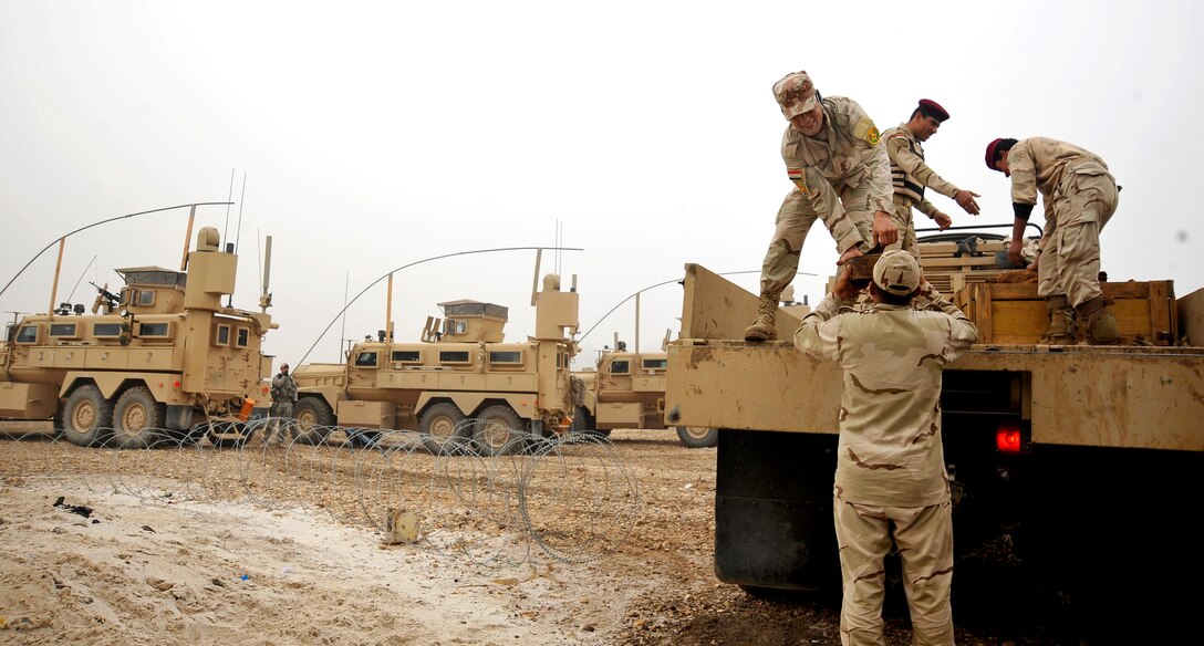 Iraqi soldiers gather explosives for a controlled detonation of captured enemy weapons on Forward Operating Base Mahmudiyah, Iraq, Nov. 23, 2009. The purpose of the detonation is to mitigate explosive hazards and limit enemy warfighting capabilities by destroying captured munitions.