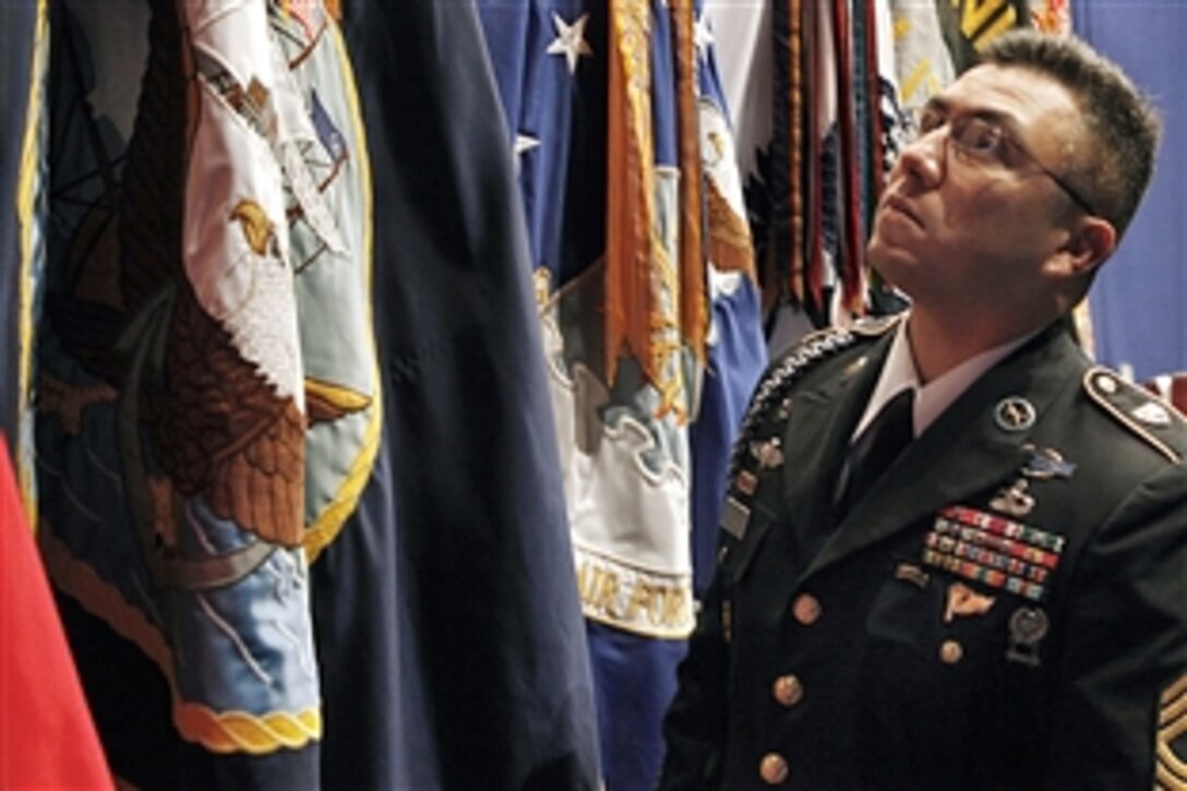 U.S. Army Master Sgt. Santiago Perales inspects a flag display set up at Eisenhower Hall for President Barack Obama’s visit to the U.S. Military Academy at West Point to speak about adding troops in Afghanistan, Dec. 1, 2009. Perales is the noncommissioned officer-in-charge of the G-3, Operations and Plans, office.