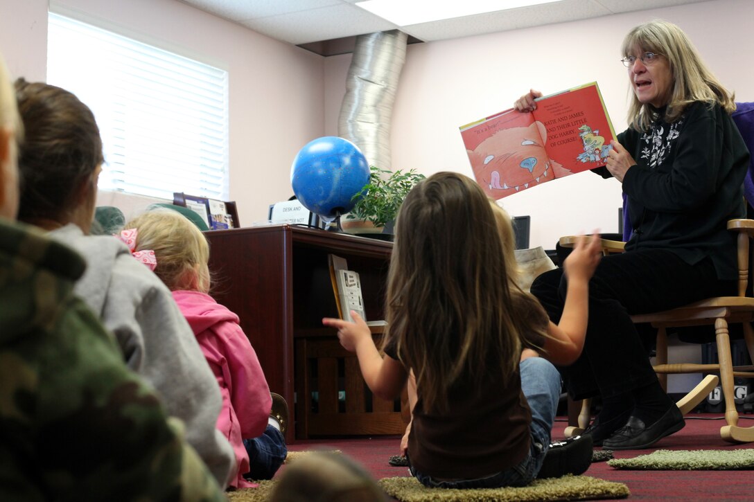 Barbara Giberson, Marine Corps Base Camp Pendleton children’s librarian, reads a book to children during a Preschool Story Time session held at base's South Mesa library, Dec. 1. The program is designed to help children learn more about literacy in a safe and caring environment.