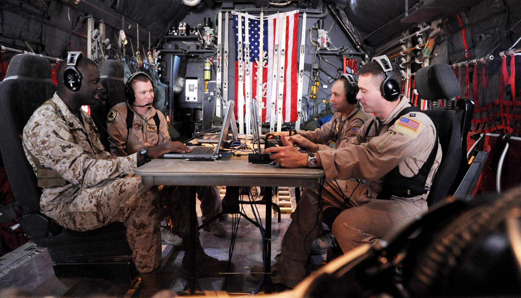 Servicemembers from the 777th Expeditionary Airlift Squadron joint airborne battle staff detachment prepare for a mission on a C-130 Hercules Nov. 24, 2009 at Joint Base Balad, Iraq. The JABS is a joint operation focused on providing airborne communications support to ground forces. (U.S. Air Force photo/Senior Airman Christopher Hubenthal)