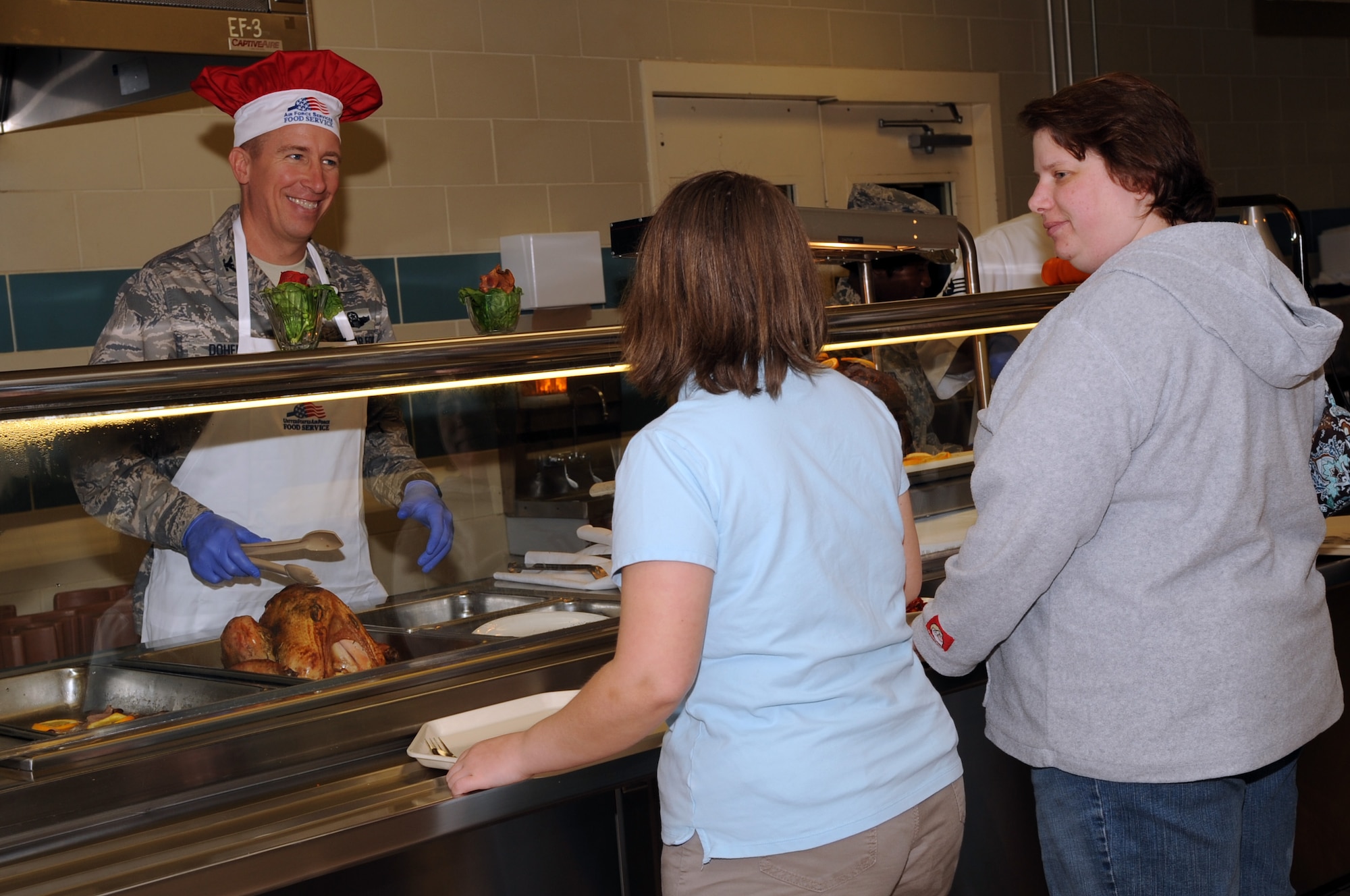 Col. Patrick J. Doherty, 4th  Fighter Wing vice commander, serves Thanksgiving Day Dinner to members of the base community on Seymour Johnson Air Force Base, N.C., Nov. 26, 2009. Commanders from 4th FW squadrons served a holiday dinner to Airmen and retirees, at the Southern Eagle Dining Facility. (U.S. Air Force photo/Senior Airman Courtney Richardson)