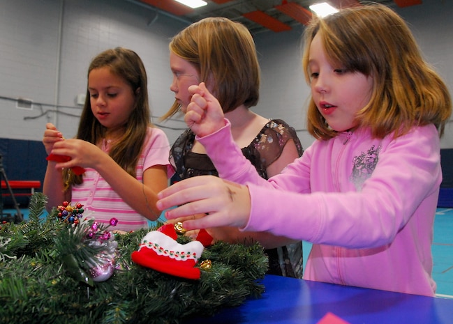 Kyler Brant, right, Hailey Lippy and Jessenia Tellado, left, work together to decorate a holiday wreath at the Youth Programs Center here Dec. 1. The wreaths were decorated as part of a donation program for the Medical University of South Carolina Children's Hospital, giving Charleston AFB children the to opportunity to reach out to the local community during the holidays. Kyler is the daughter of Tech. Sgt. Katie Brant who is with the 315th Airlift Wing, Hailey is the daughter of Tech. Sgt. Keith Lippy who is with the 437th Security Forces Squadron and Jessenia is the daughter of Senior Airman Ricardo Tellado who is with the 437th Civil Engineer Squadron. (U.S. Air Force photo/Staff Sgt. Daniel Bowles)

