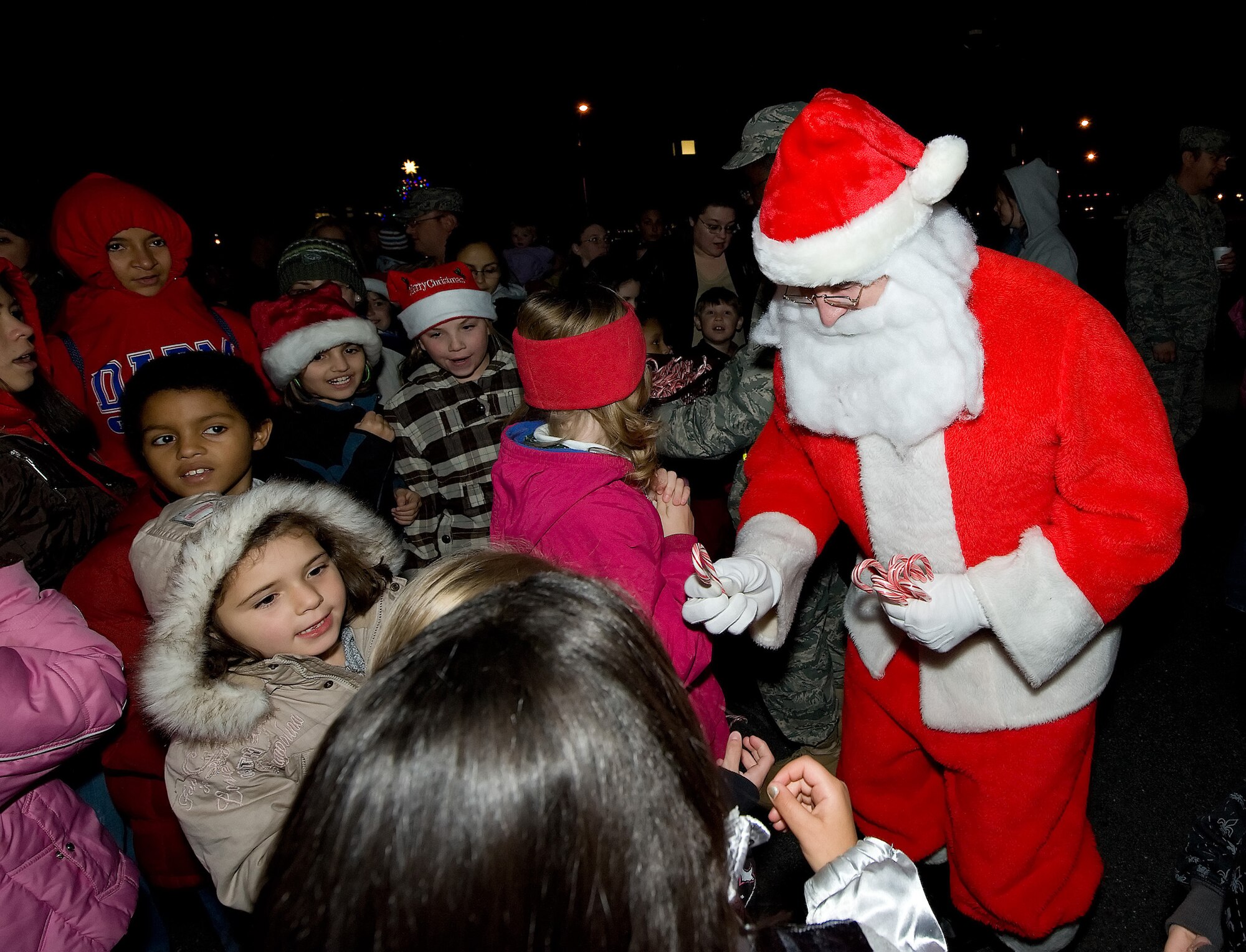 Santa Claus handed out candy canes during Dover?s Christmas Tree lighting ceremony Dec. 1. He posed for photos with the children and their families. (U.S. Air Force photo/Jason Minto)