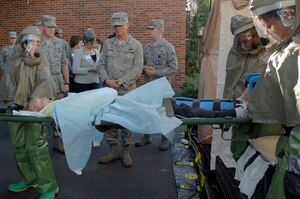 Lt. Gen. Robert Allardice, center, and Chief Master Sgt. James Cody, back left, observe a training exercise being performed by the 437th Medical Group here Dec. 1. General Allardice visited Charleston AFB on a two-day visit after assuming command of the 18th Air Force Aug. 19, 2009. General Allardice is the 18th Air Force commander and Chief Cody is the 18th Air Force command chief. (U.S. Air Force photo/Airman 1st Class Lauren Laidlaw)