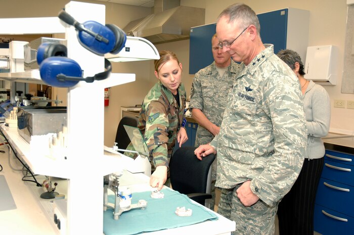Senior Airman Meghan Mayhew shows Lt. Gen. Robert Allardice and Chief Master Sgt. James Cody a mold of a set of teeth during a tour of the 437th Medical Group here Dec. 1. General Allardice visited Charleston AFB on a two-day visit after assuming command of the 18th Air Force Aug. 19, 2009.  General Allardice is the 18th Air Force commander, Chief Cody is the 18th Air Force command chief and Airman Mayhew is assigned to the 437th Medical Group as a dental lab technician. (U.S. Air Force photo/Airman 1st Class Lauren Laidlaw)