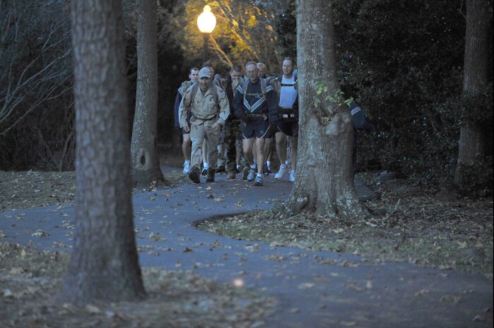 Lt. Gen. Robert Allardice, right, and Tech. Sgt. Raymond Pomeroy, left, lead members of the 437th Airlift Wing and the explosive ordnance disposal team on a 1.5 mile ruck pack march around McCombs Way here Dec. 1. General Allardice stopped at Charleston AFB for a two-day visit as part of his tour of the bases within his command. General Allardice is the 18th Air Force commander and Sergeant Pomeroy is the EOD superintendent assigned to the 437th Civil Engineer Squadron. (U.S. Air Force photo/Staff Sgt. Marie Brown)